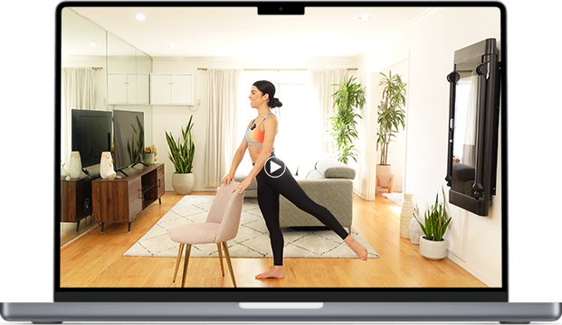 Woman stretching in living room with plants and furniture