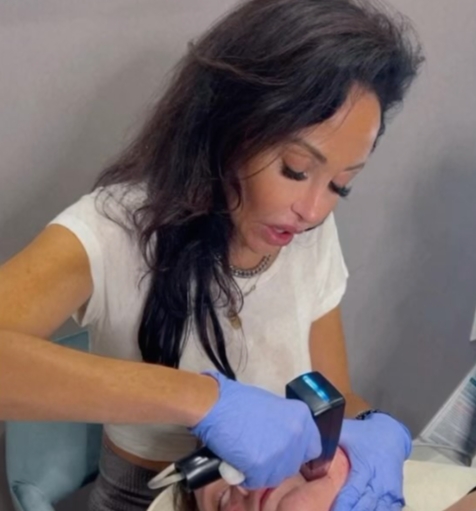 A woman with dark hair giving a Morpheus treatment.