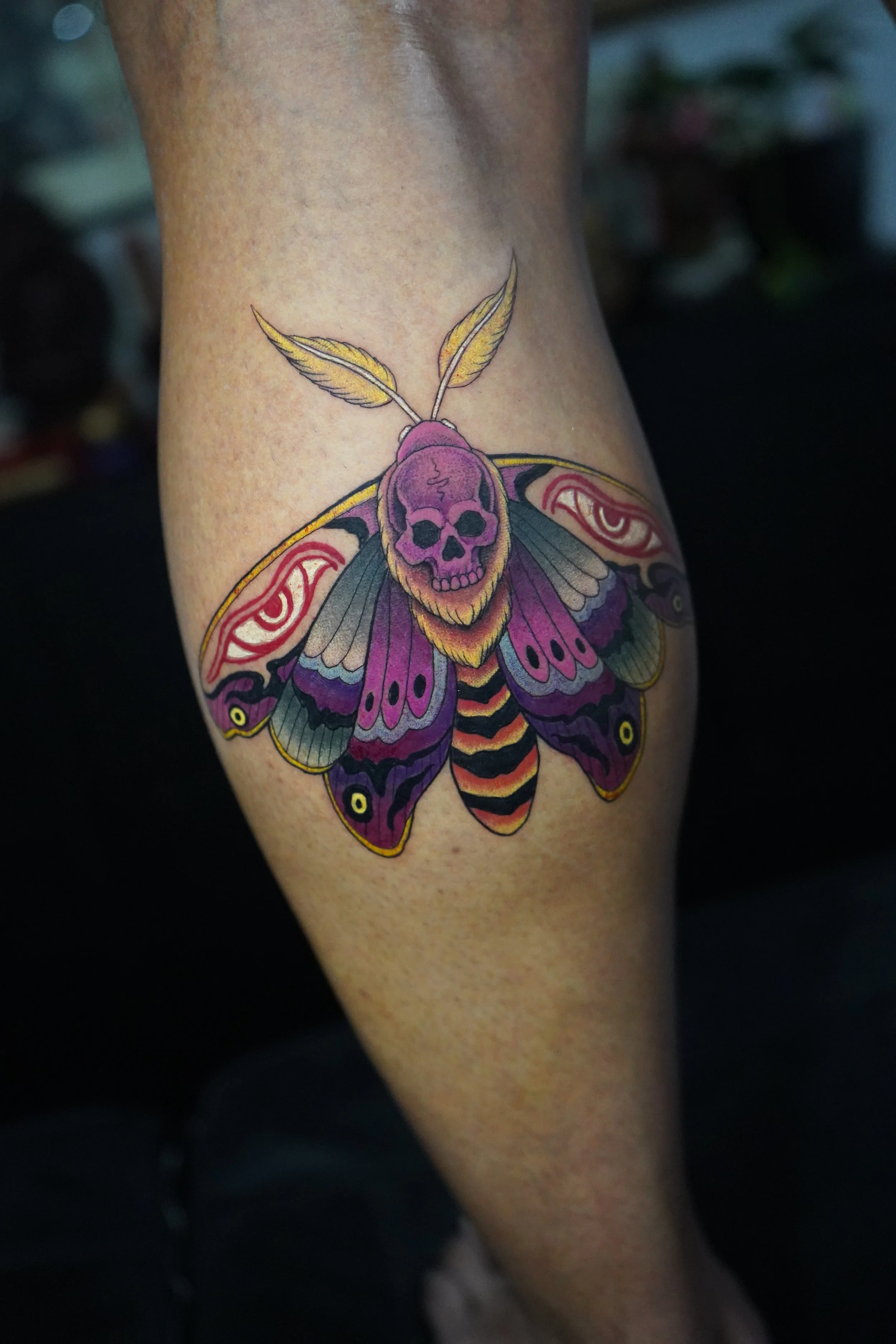 44 moth buddha eyes leg tattoo.jpg