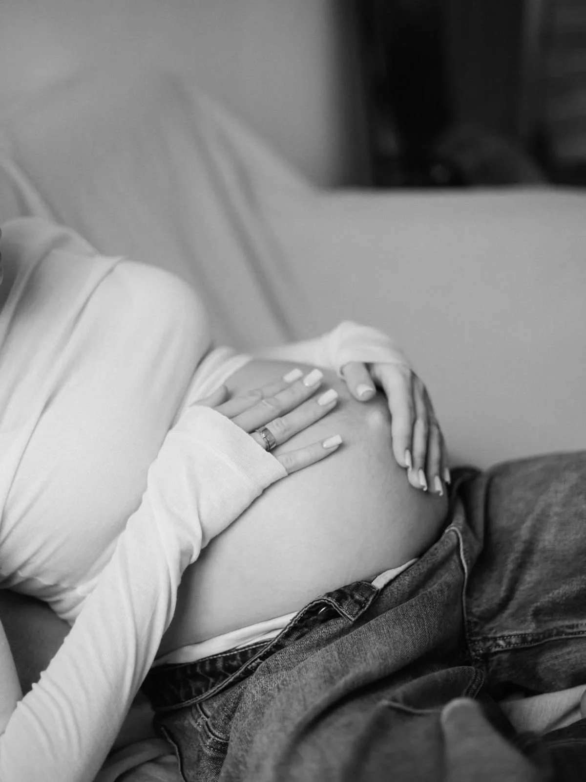 Close-up view of an ornate temple corner with detailed architectural carvings and decorative sculptures against a clear blue sky.