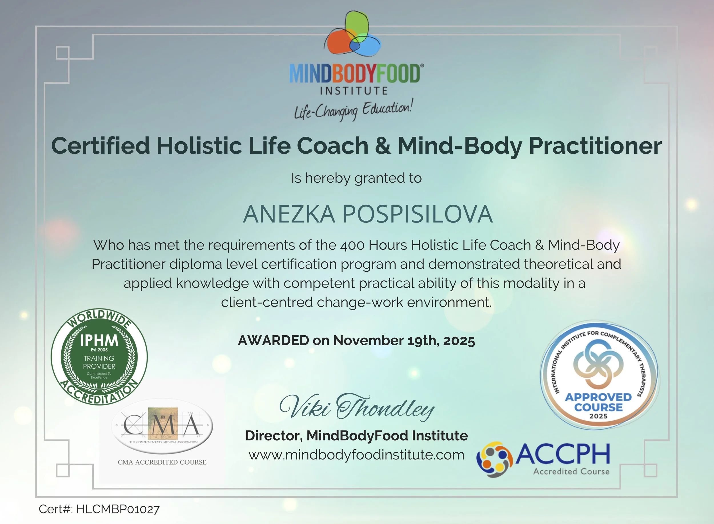 Certificate awarded to Anezka Pospisilova by the MindBodyFood Institute for completing a Holistic Life Coach and Mind-Body Practitioner program, dated November 19th, 2025, signed by Viki Thondley, featuring logos of accreditation organizations, and a light blue background with decorative borders.