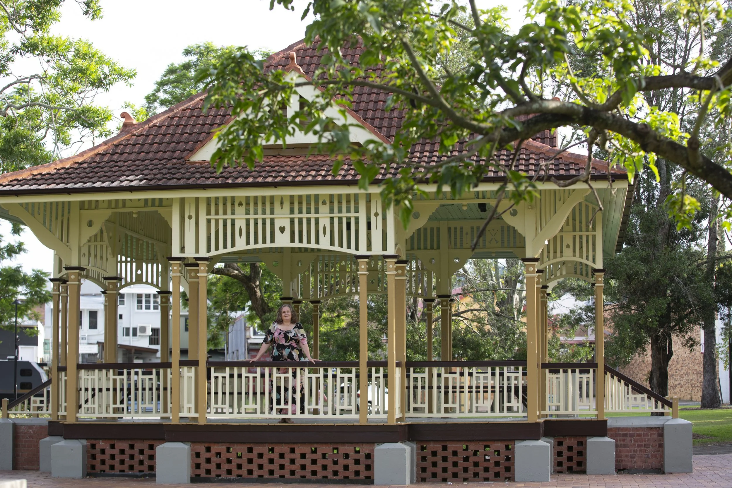 Woman standing in a garden gazebo in Gympie surrounded by greenery
