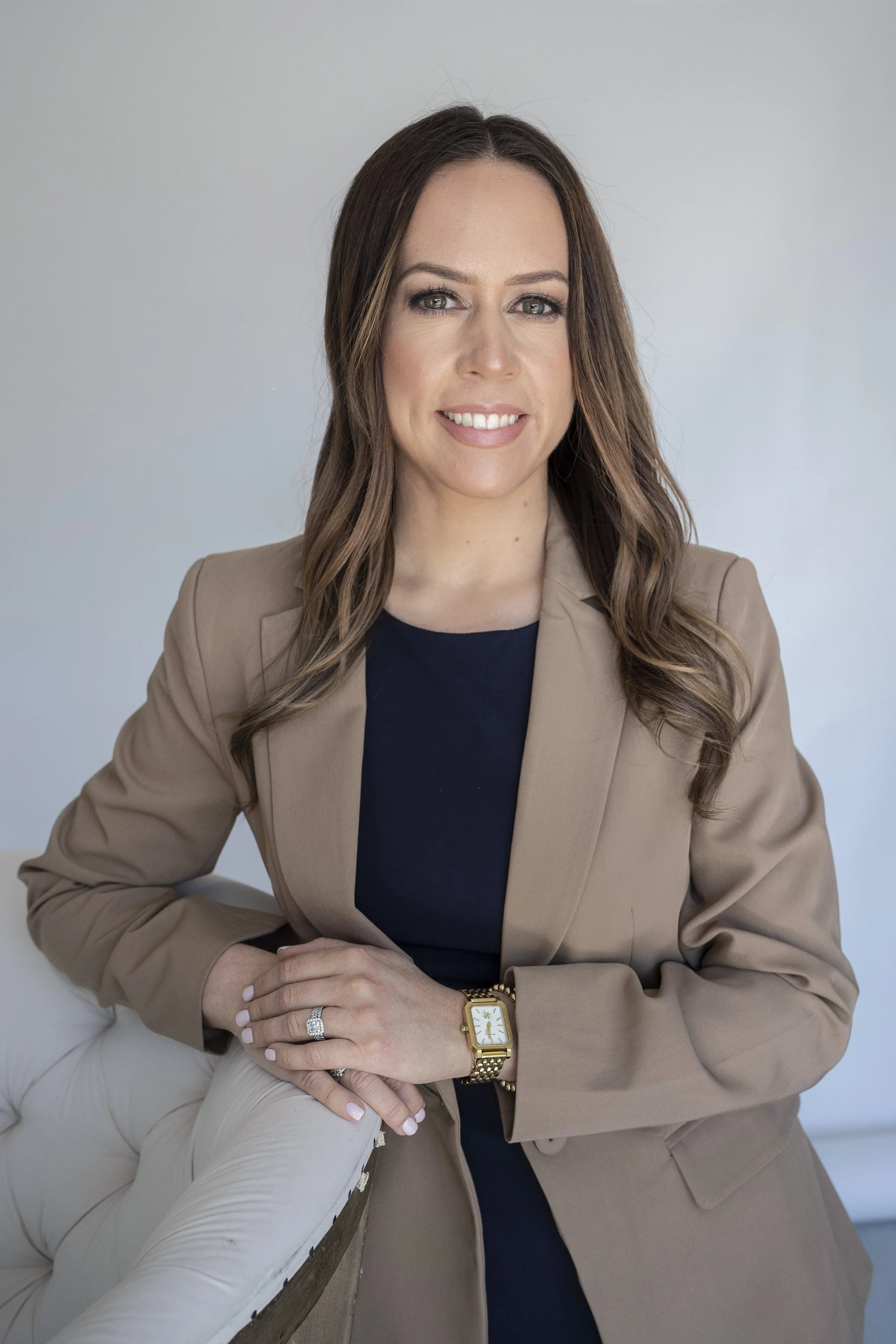 Justine Carino, anxiety coach for high-achieving women leaning on a chair