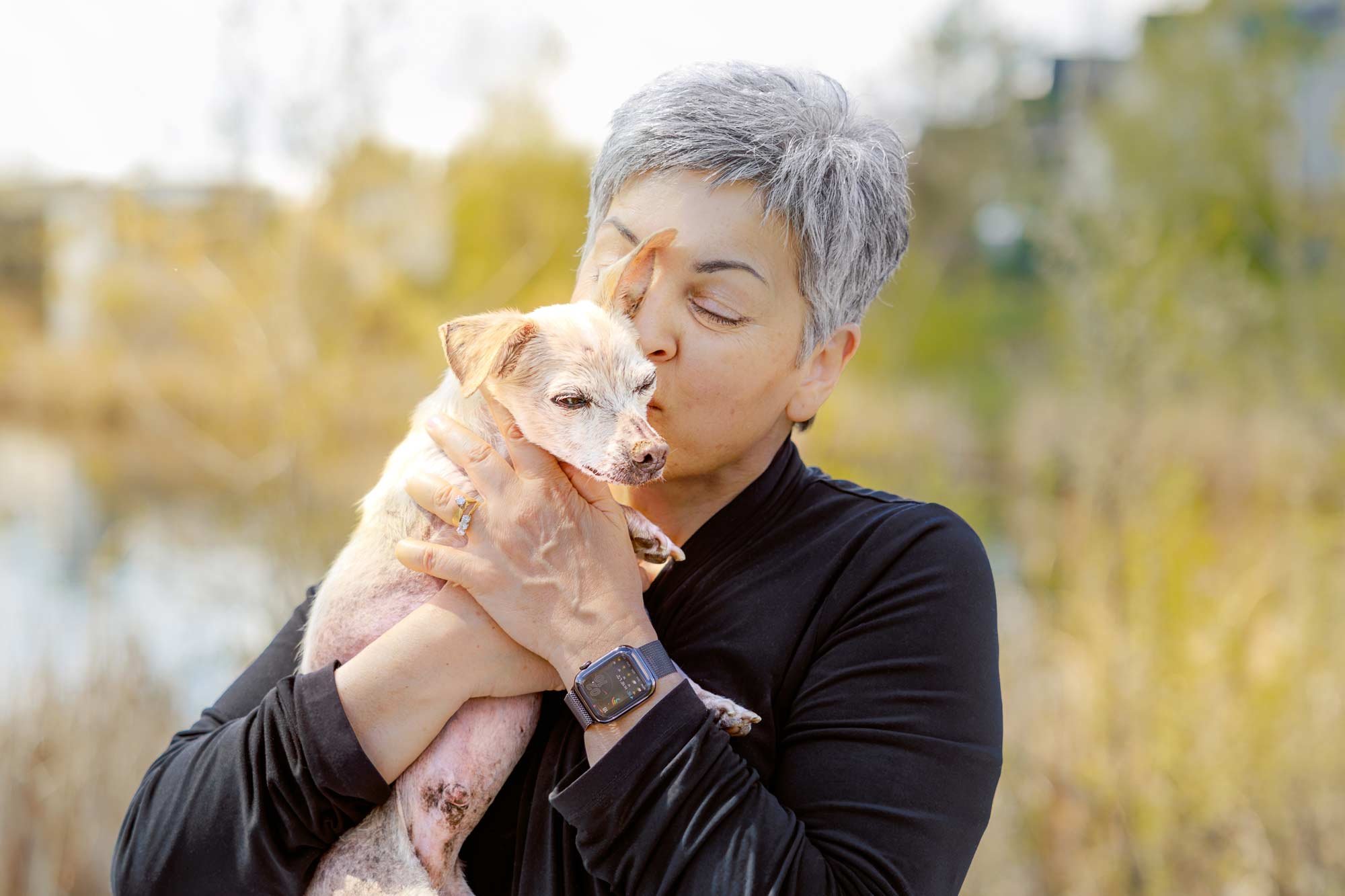 Dog Mom kissing her sweet senior Chihuahua rescue