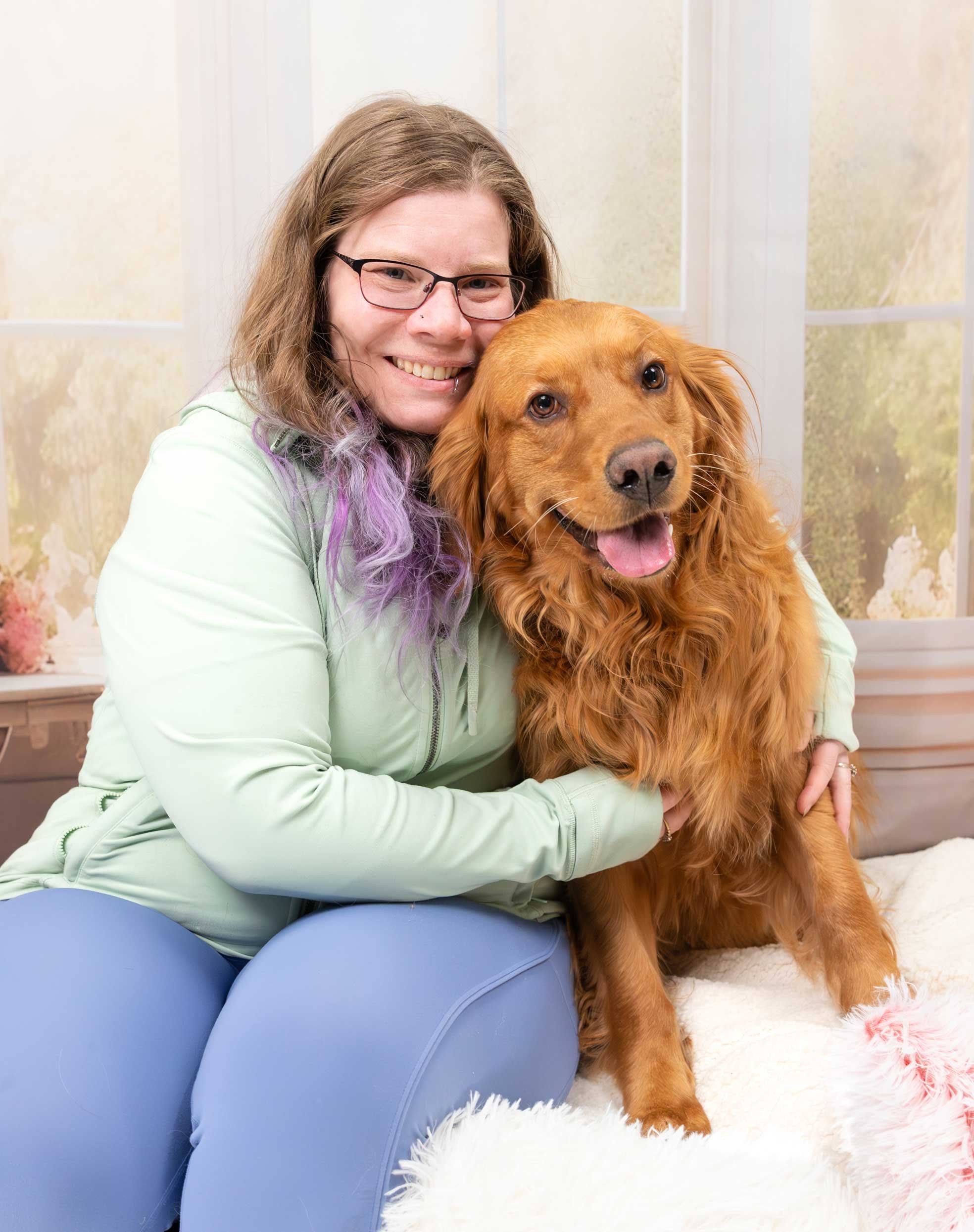 Dog family portrait – a smiling dog Mom and her happy Golden Retriever cuddle for a photo
