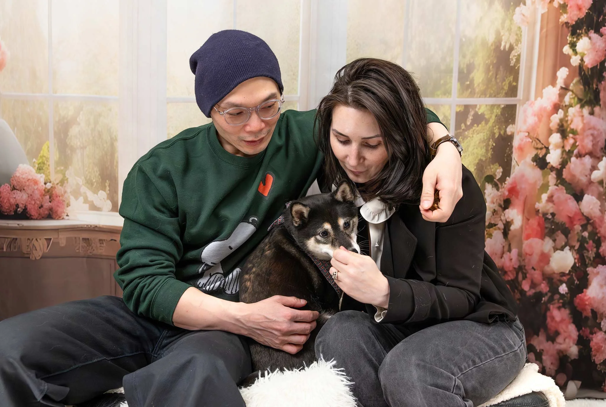 Dog family portrait -- with Dog Mom and Dog Dad hugging a shy Shiba Inu