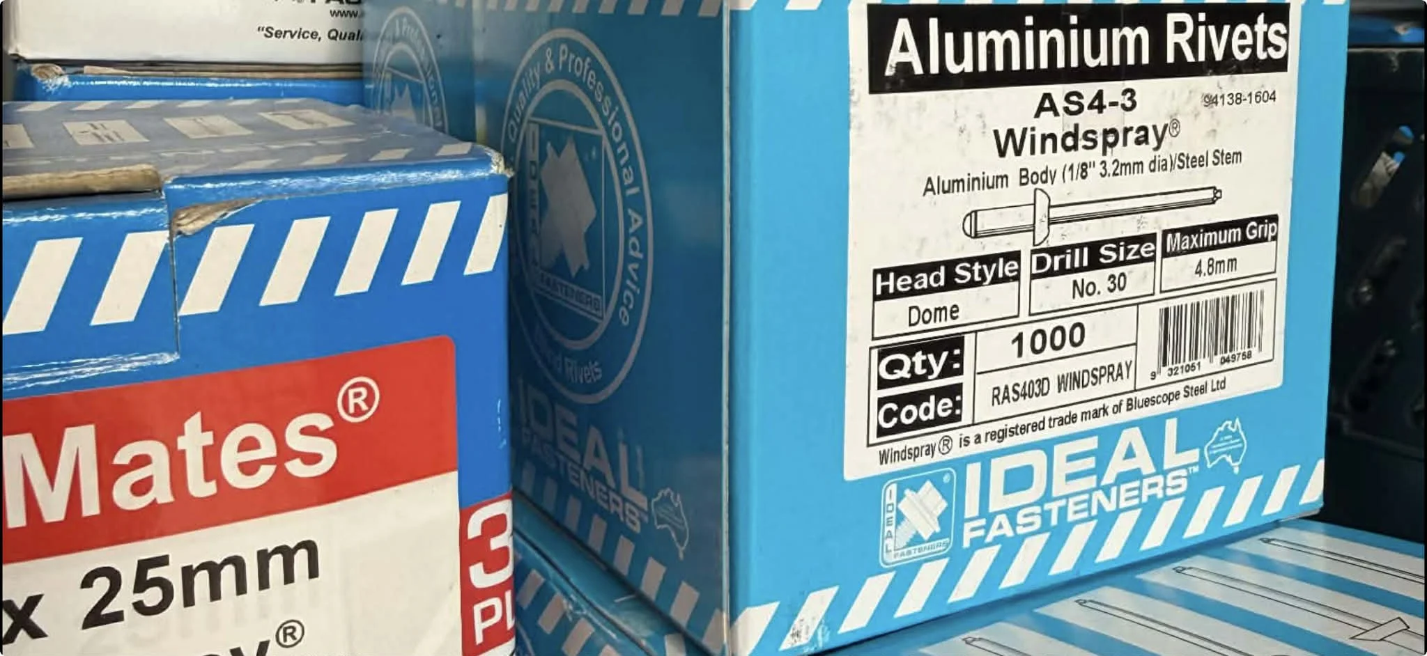 Close-up of packages of aluminum rivets and fasteners on store shelves, with labels indicating sizes and quantities.