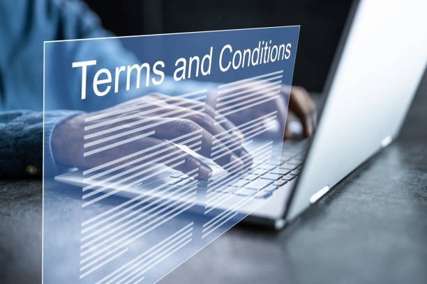 Person typing on a laptop with a virtual display labeled 'Terms and Conditions' hovering over the keyboard.