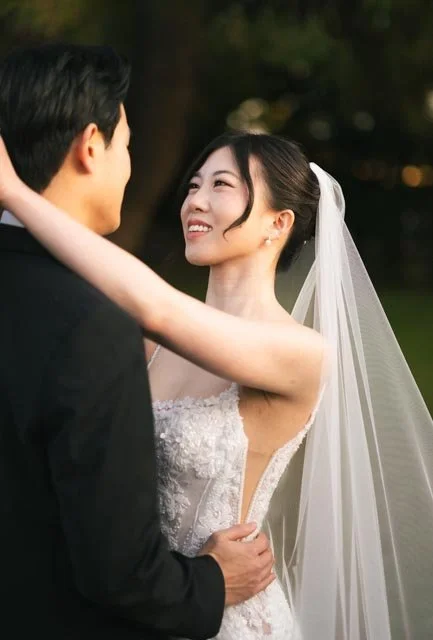 A bride and groom looking at each other during their wedding outdoor ceremony