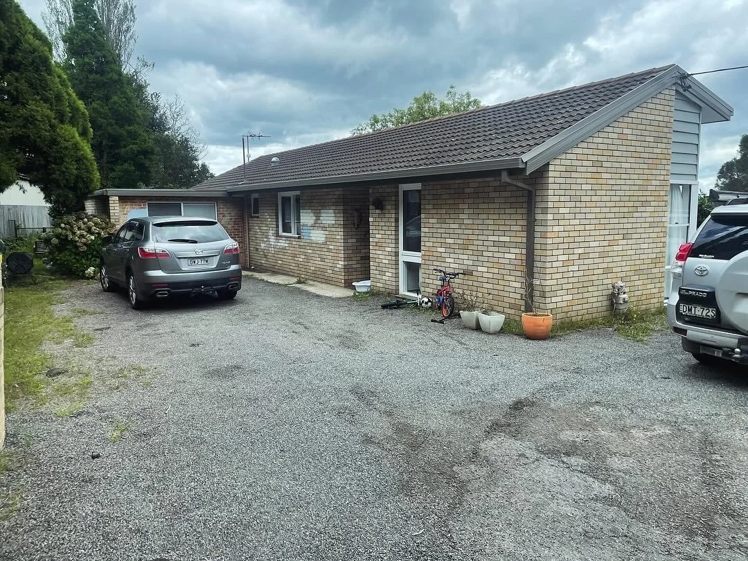 Before and After: A front facade with a whole new story. 

Swipe to see the transformation - from dated and closed-off to fresh, welcoming and full of character. We reimagined the entry, updated the materials, and brought in warmth through timber, te