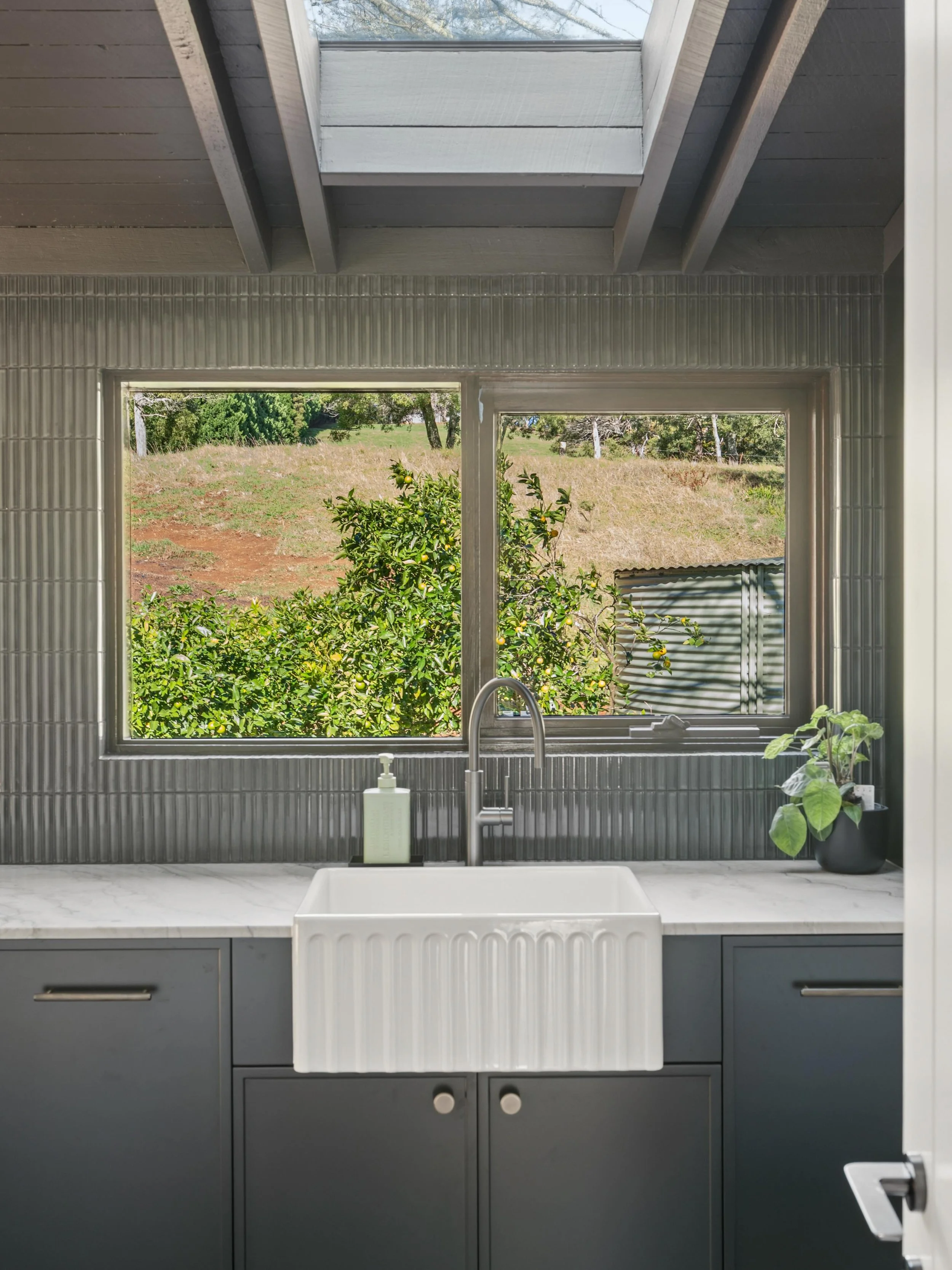 Rich finishes and a moody palette bring depth@and warmth to this generous space, while a skylight draws in natural light to soften and elevate the experience. 

Even the most hardworking spaces in a home deserve thoughtful attention. 

#merrigangcons