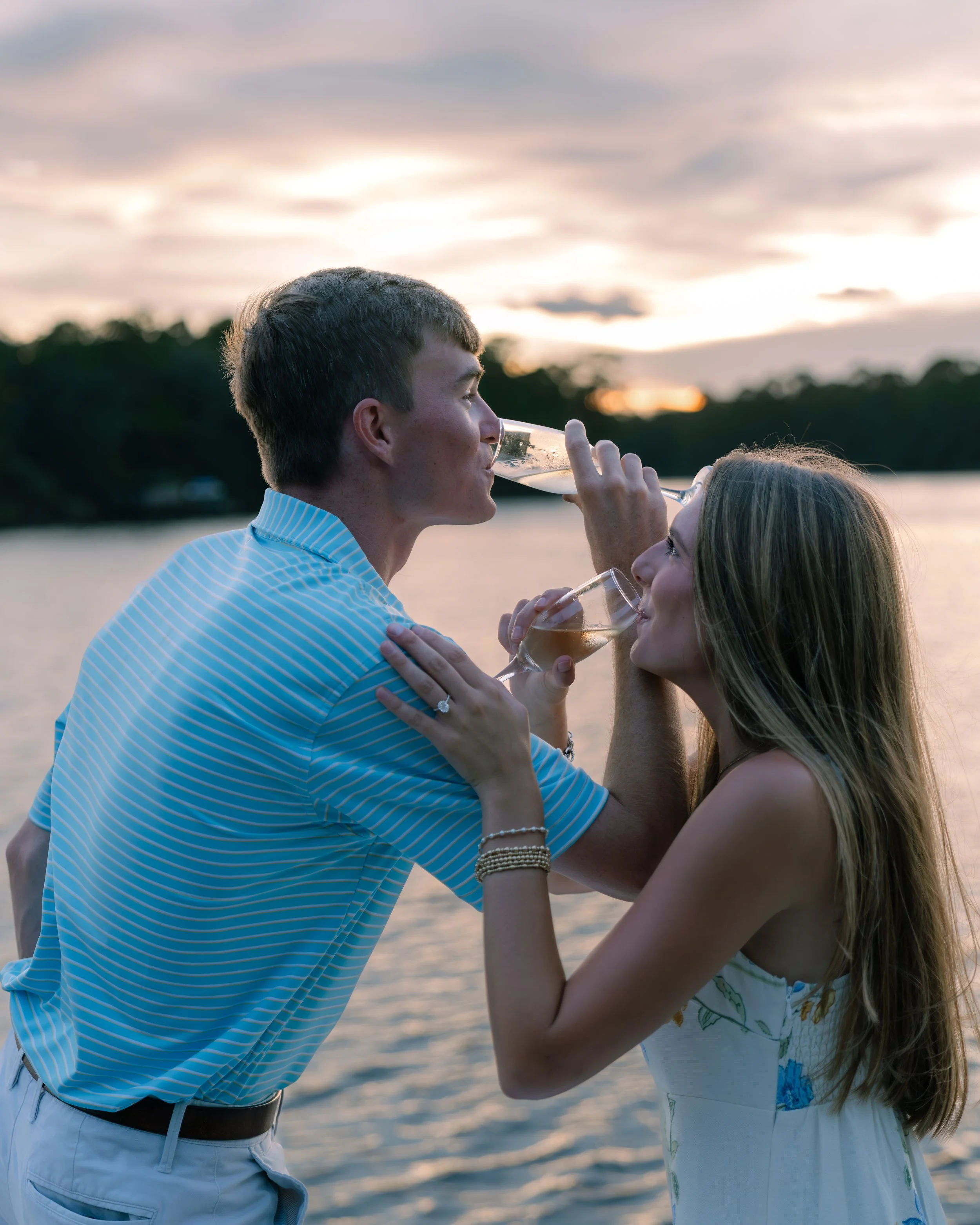 Man and woman lock arms and drink champagne. 30A Photographer