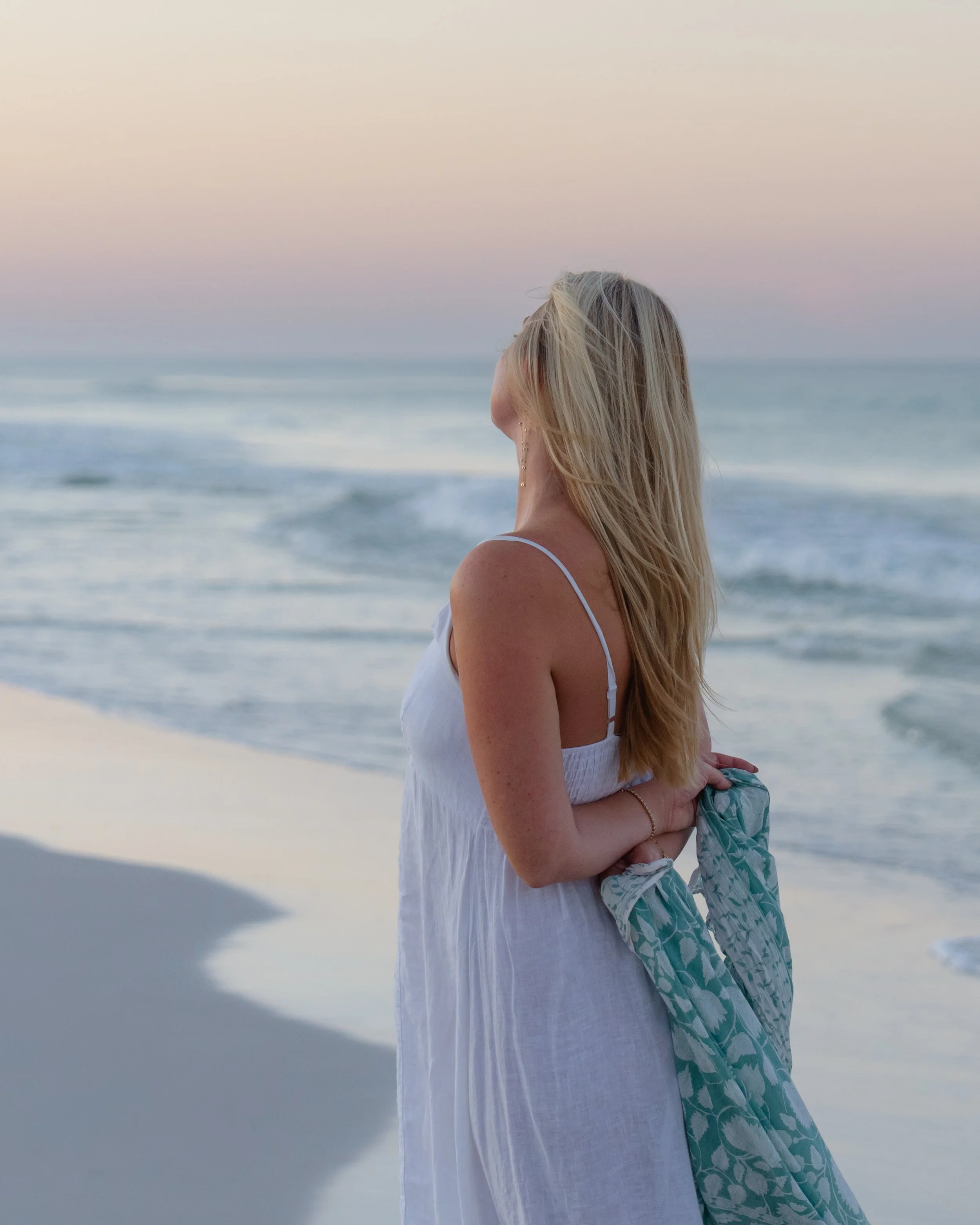 Portrait of a woman walking on the beach toward the ocean. Grayton Beach Photographer. 30A Photographer