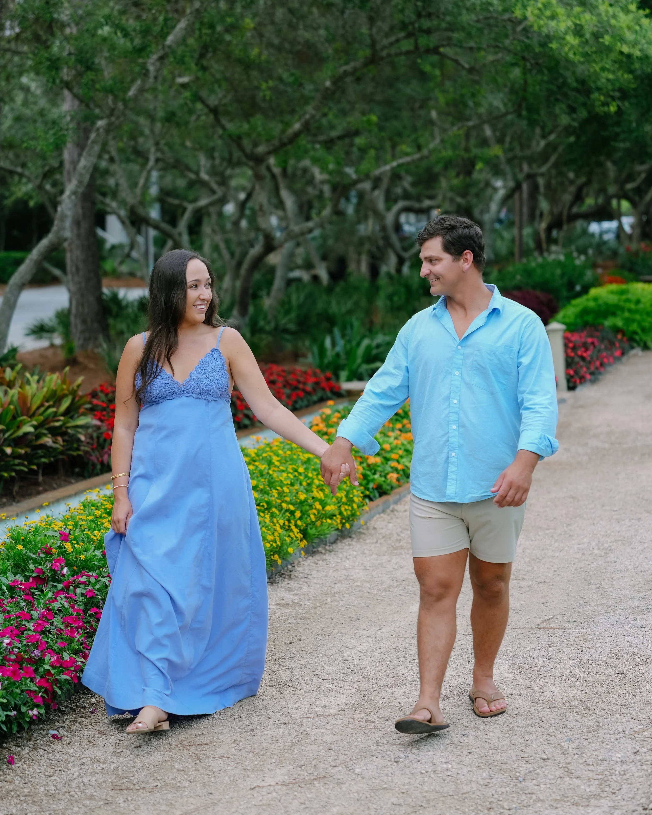 Man and Woman walking and smiling at each other in a park in Watercolor, Florida. 30A Photographer