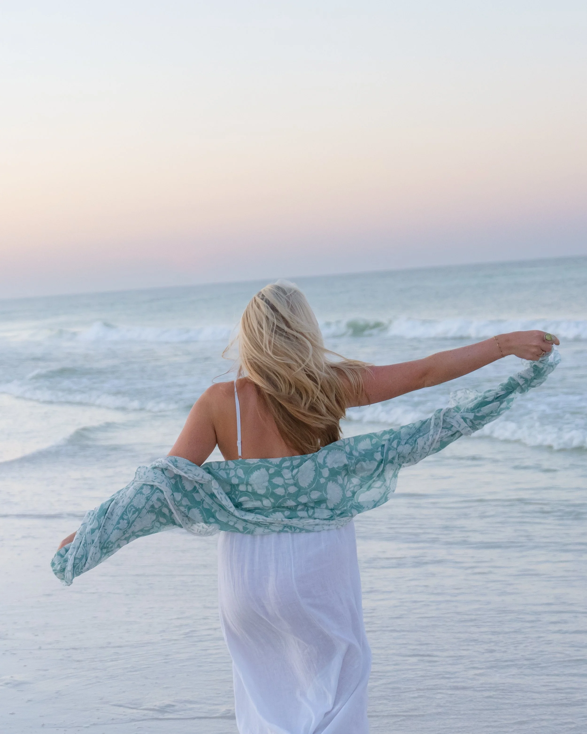 Portrait of a woman walking on the beach toward the ocean. Grayton Beach Photographer. 30A Photographer