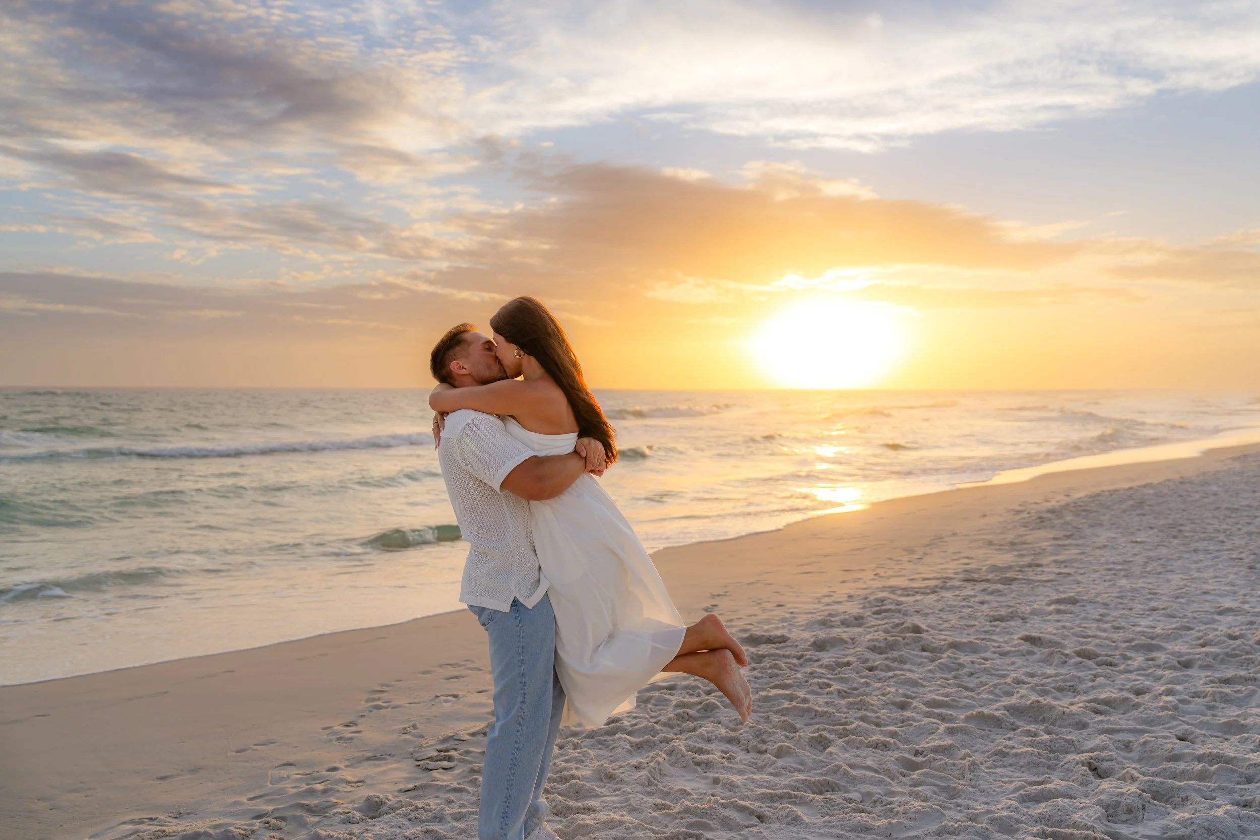 Man and woman hugging and kissing after a 30A Engagement Photos session