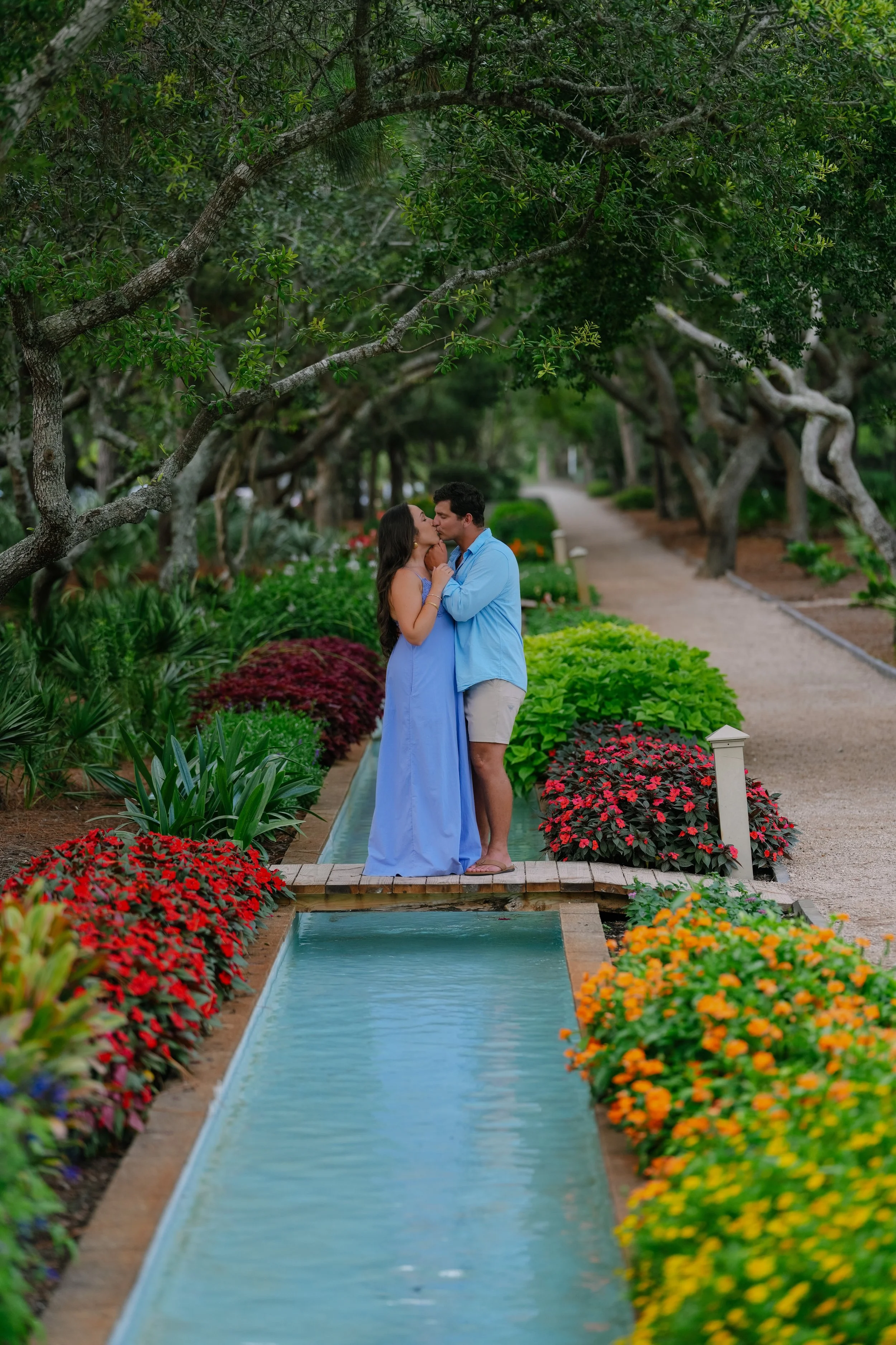 Man and Woman kissing each other in a park in Watercolor, Florida. 30A Photographer