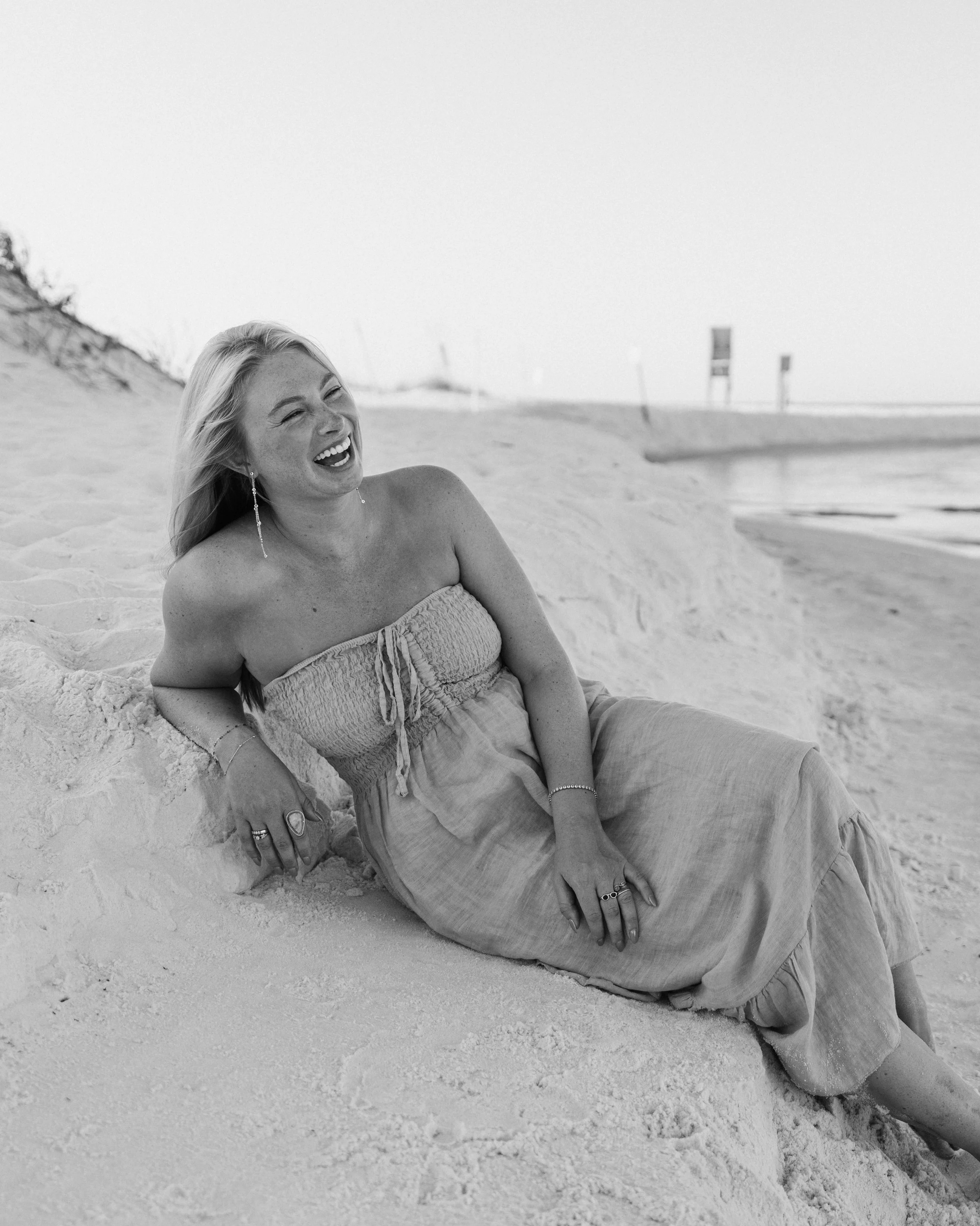 Girl Laughing while sitting on the beach in Grayton Beach, Florida. 30A Photographer