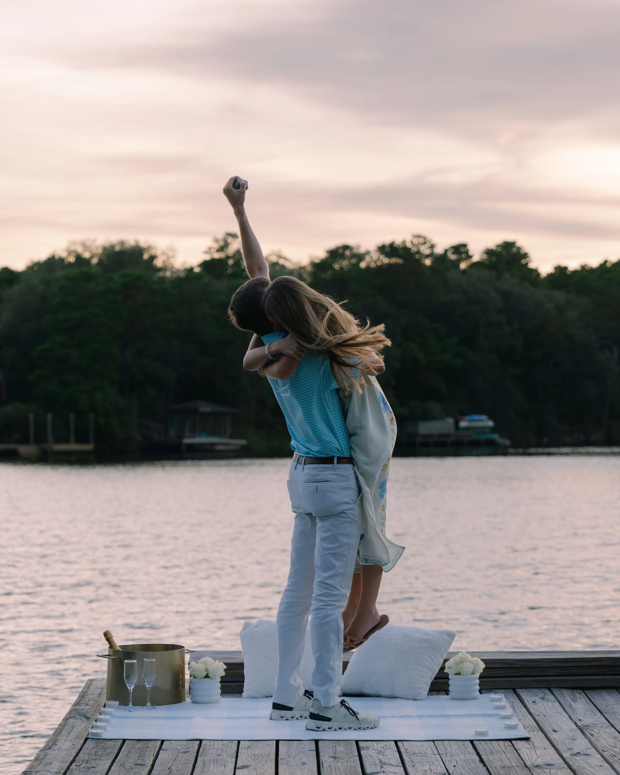 Man and woman embracing in the sunset after proposal. 30A Photographer