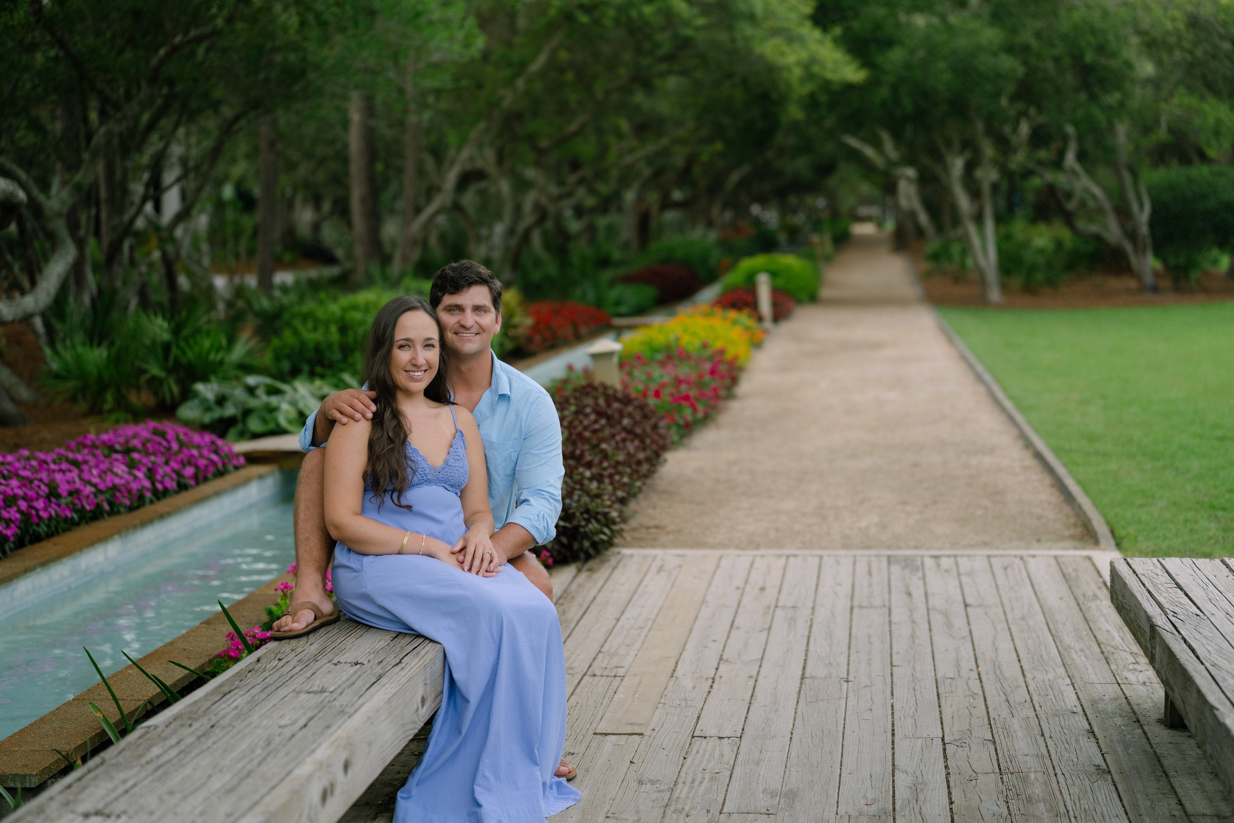Man and Woman sitting on a park bench next to each other in a park in Watercolor, Florida. 30A Photographer