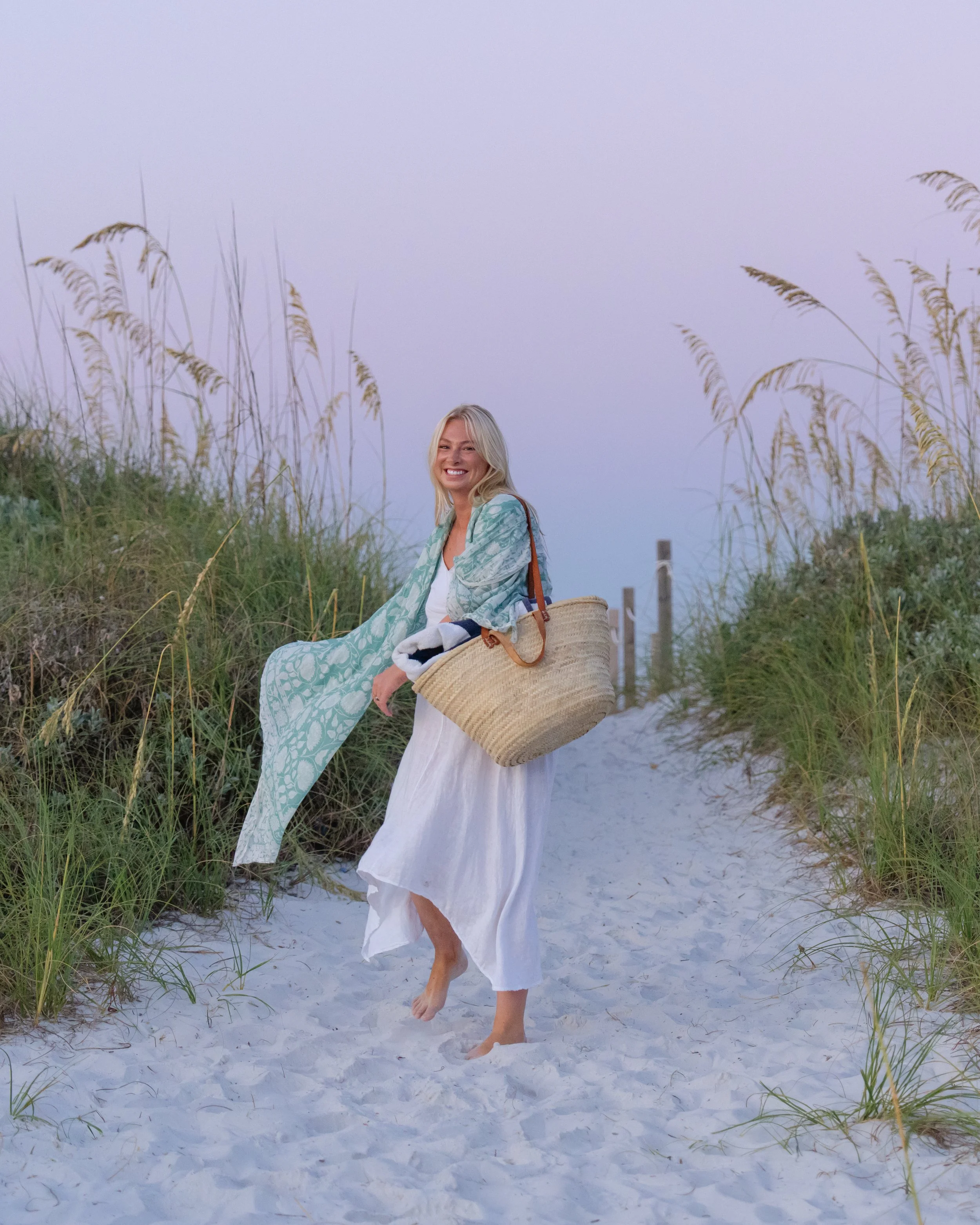 Portrait of a woman walking on a path through dunes to the beach. Grayton Beach Photographer. 30A Photographer