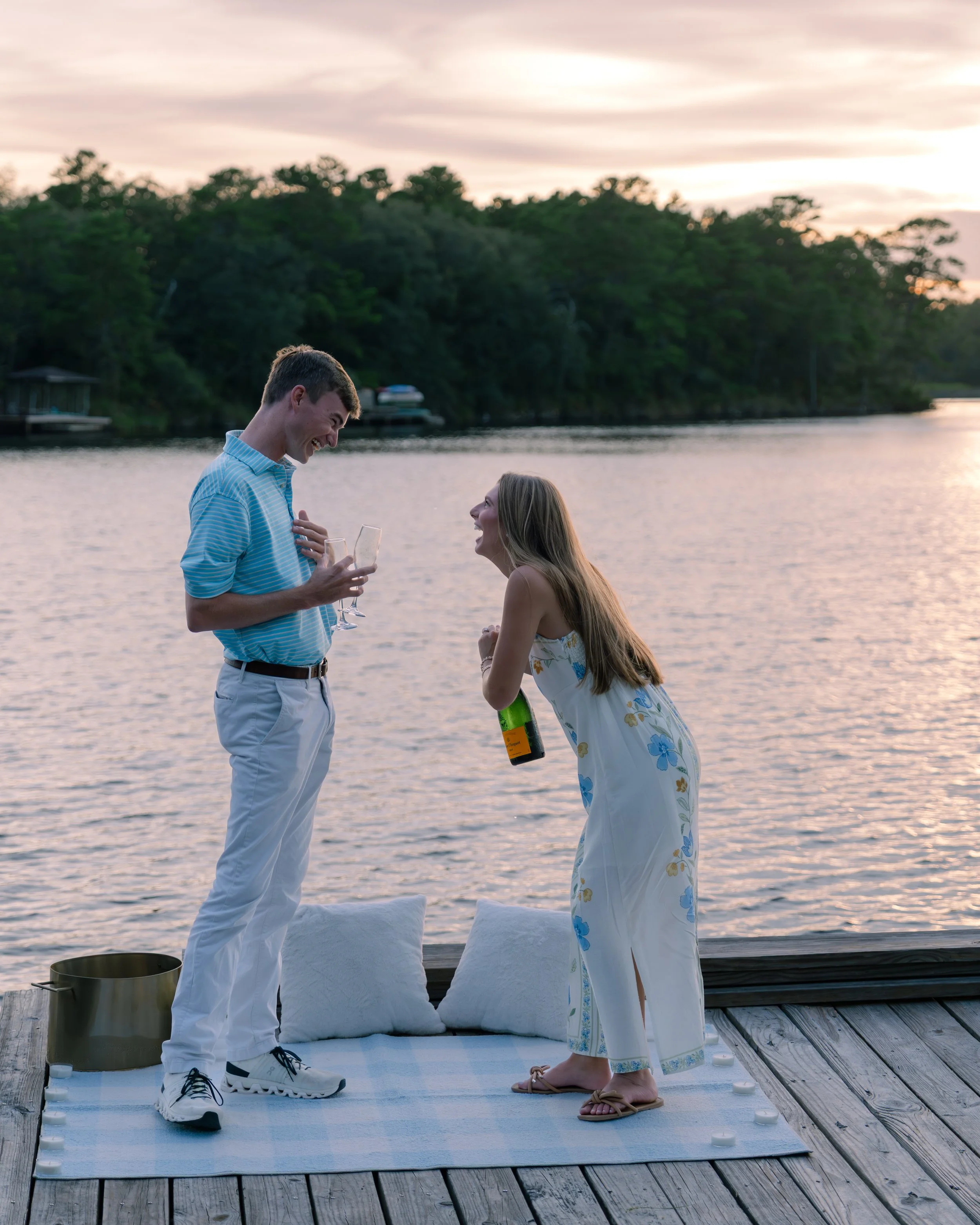 Man and woman celebrating proposal with champagne. 30A Photographer