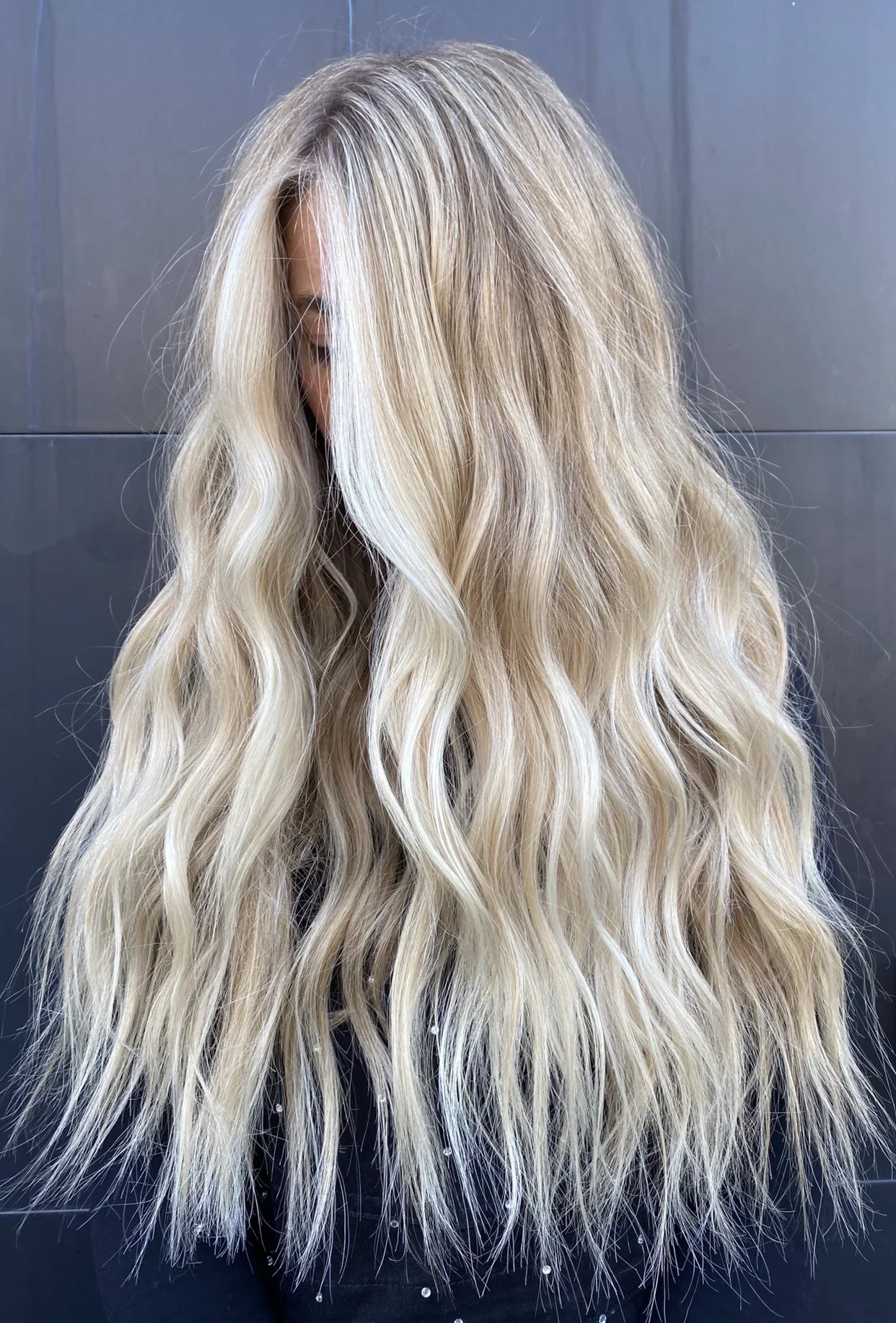 Long, wavy, blonde hair with subtle highlights.