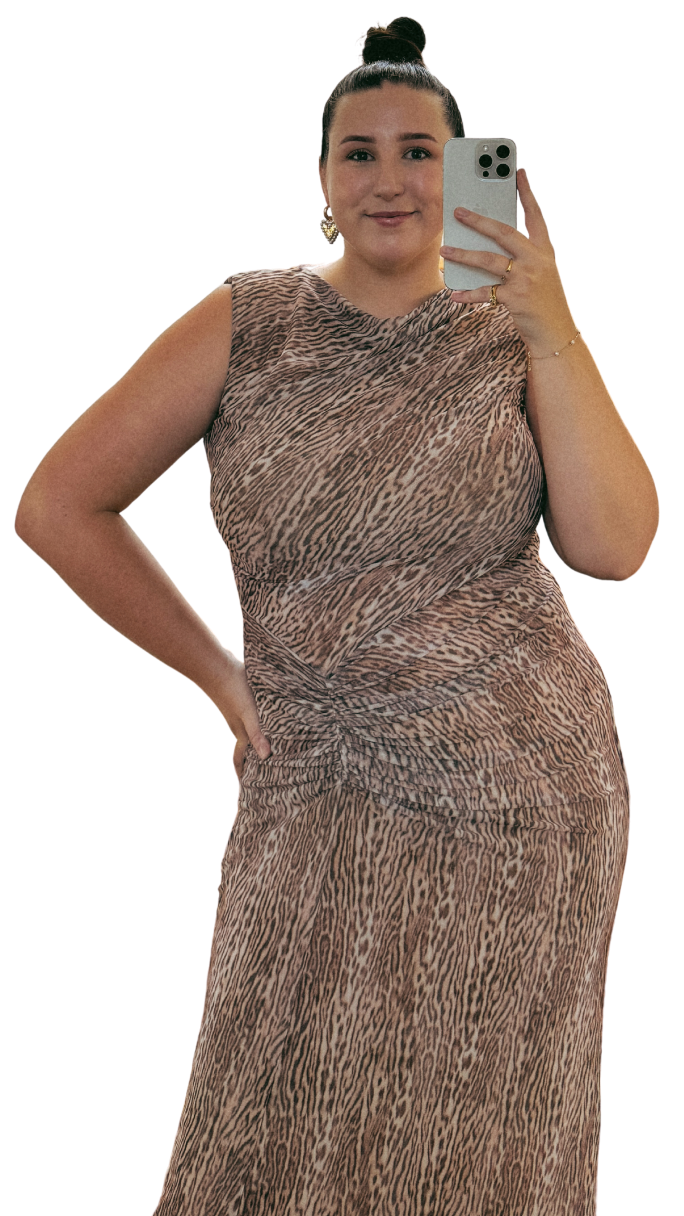 A woman in a sleeveless animal print dress taking a selfie with her smartphone.
