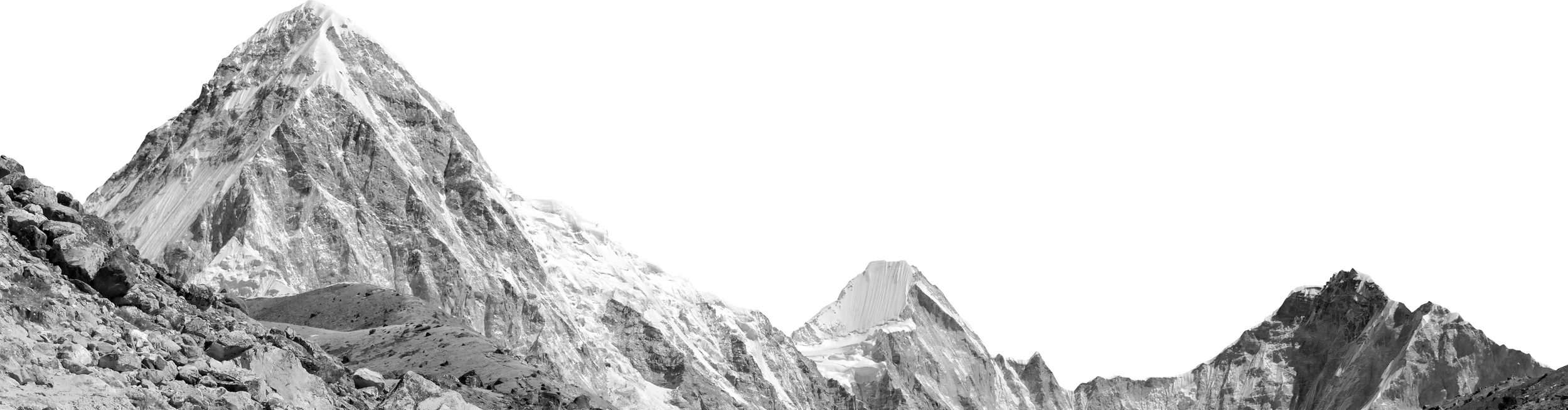 Black and white photo of mountain peaks with snow, taken from a rocky foreground.