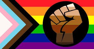 Black fist symbol in front of a rainbow and transgender pride flag. LGBTQ community, LGBTQ friendly.