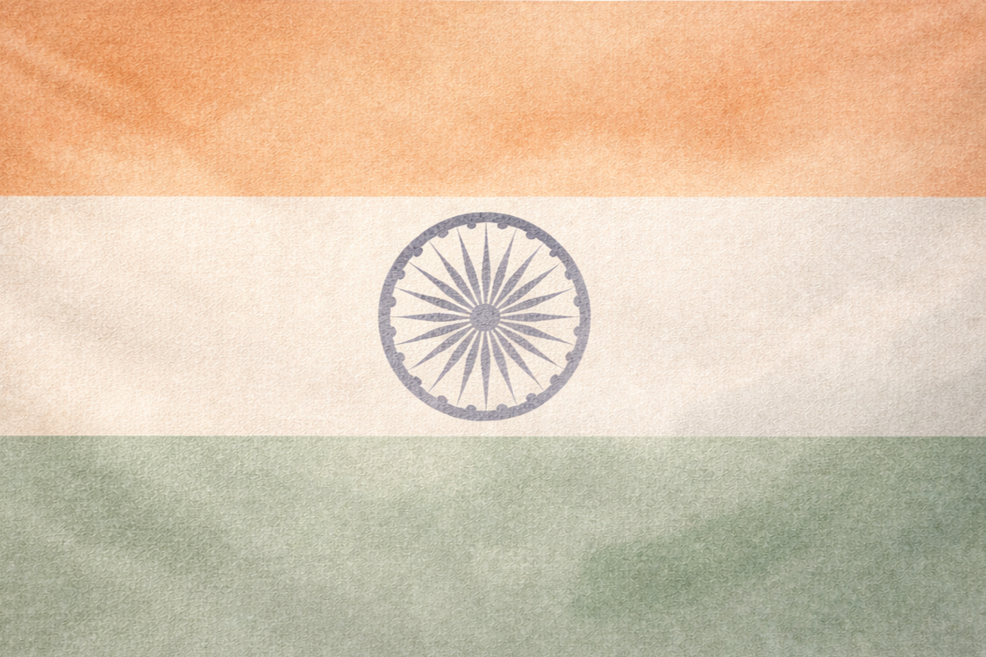The Indian flag with horizontal orange, white, and green stripes and a blue Ashoka Chakra in the center. For travellers.