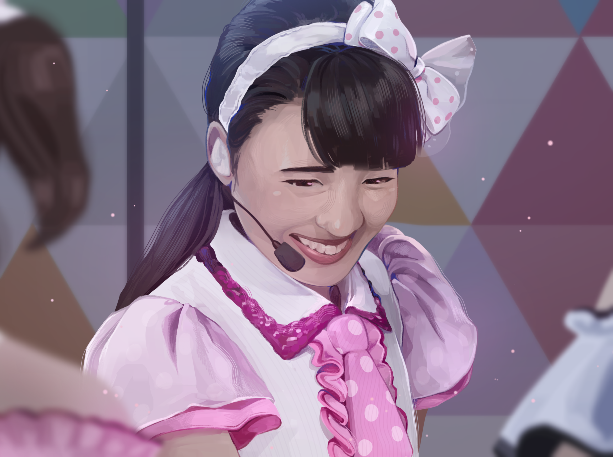 A young woman with a headset, smiling, wearing a pink and white outfit with a polka dot bow on her head, on a stage with a geometric background.