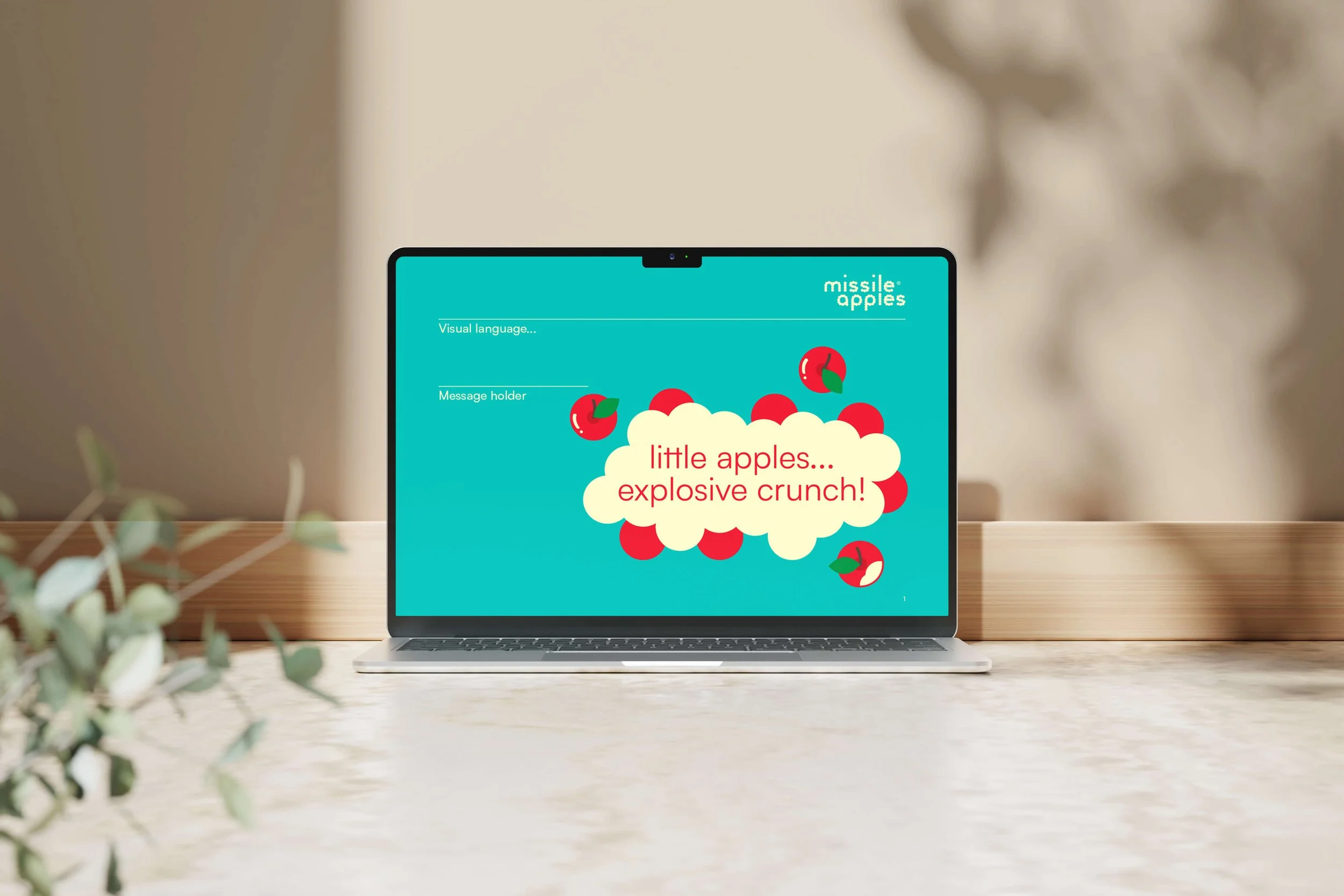 Laptop screen displaying a colorful graphic about missiles and apples, with the text 'little apples... explosive crunch!'