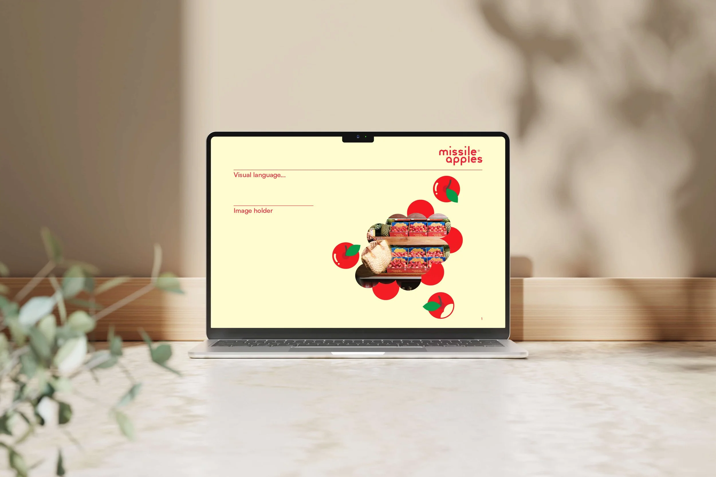 Laptop screen displaying a graphic of red apples and Missible Apples branding, with text labels 'Visual language...' and 'Image holder' on a beige background.