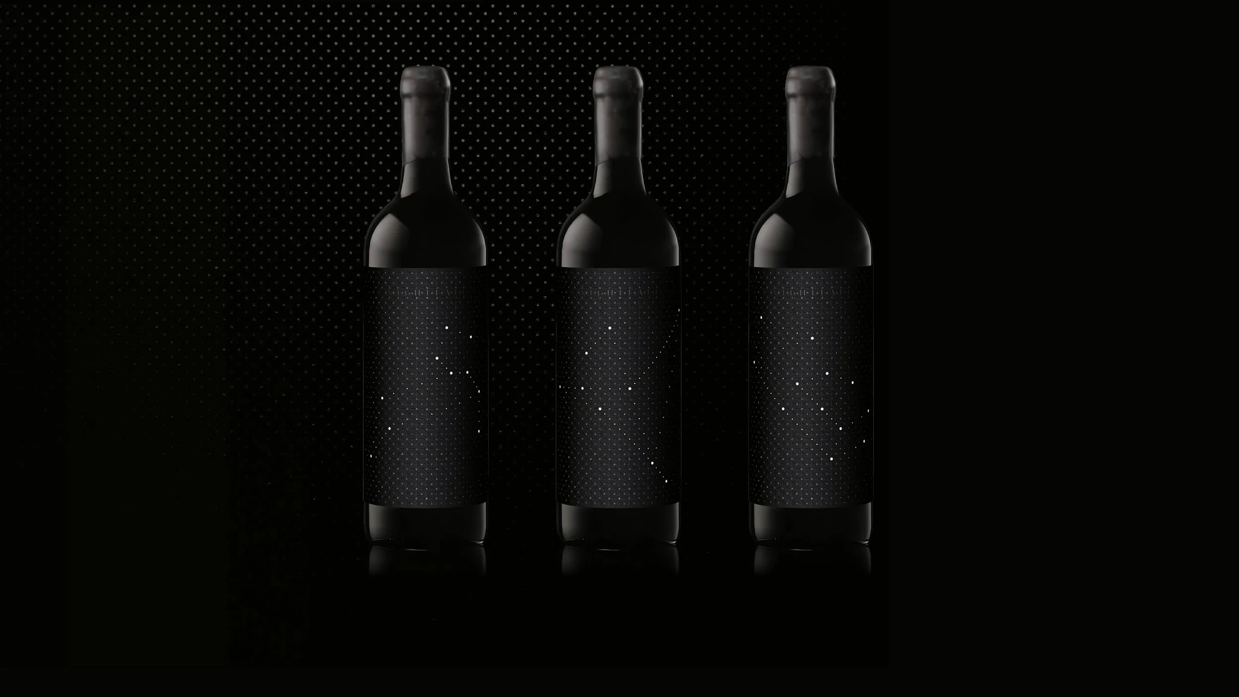 Three Nightfall Wines black wine bottles with starry night-themed labels standing side by side against a dark background.