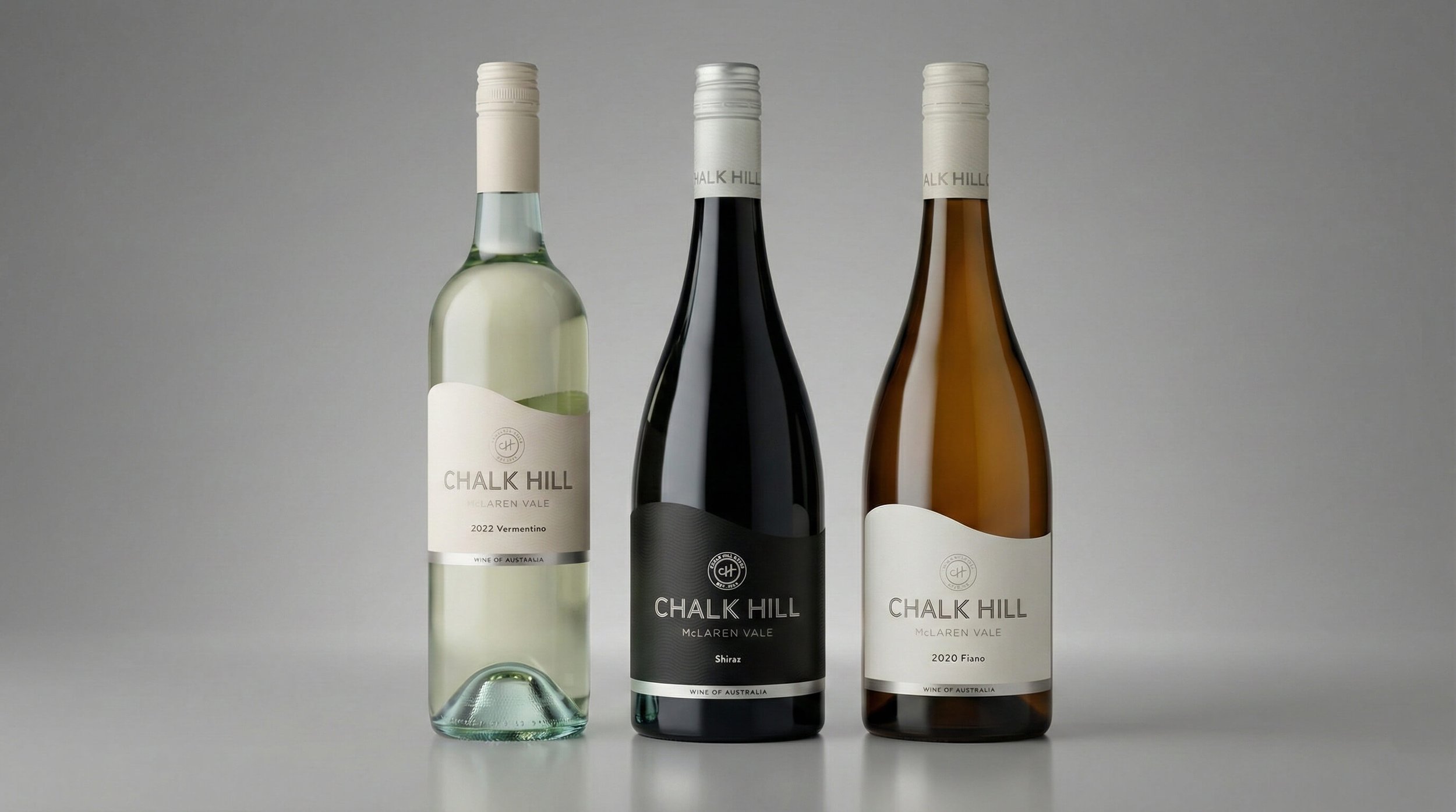 Three bottles of Chalk Hill wine from McLaren Vale, standing on a gray surface with a neutral background. The bottles are arranged side by side, with a white wine on the left, a red wine in the middle, and a rosé or light-colored wine on the right.