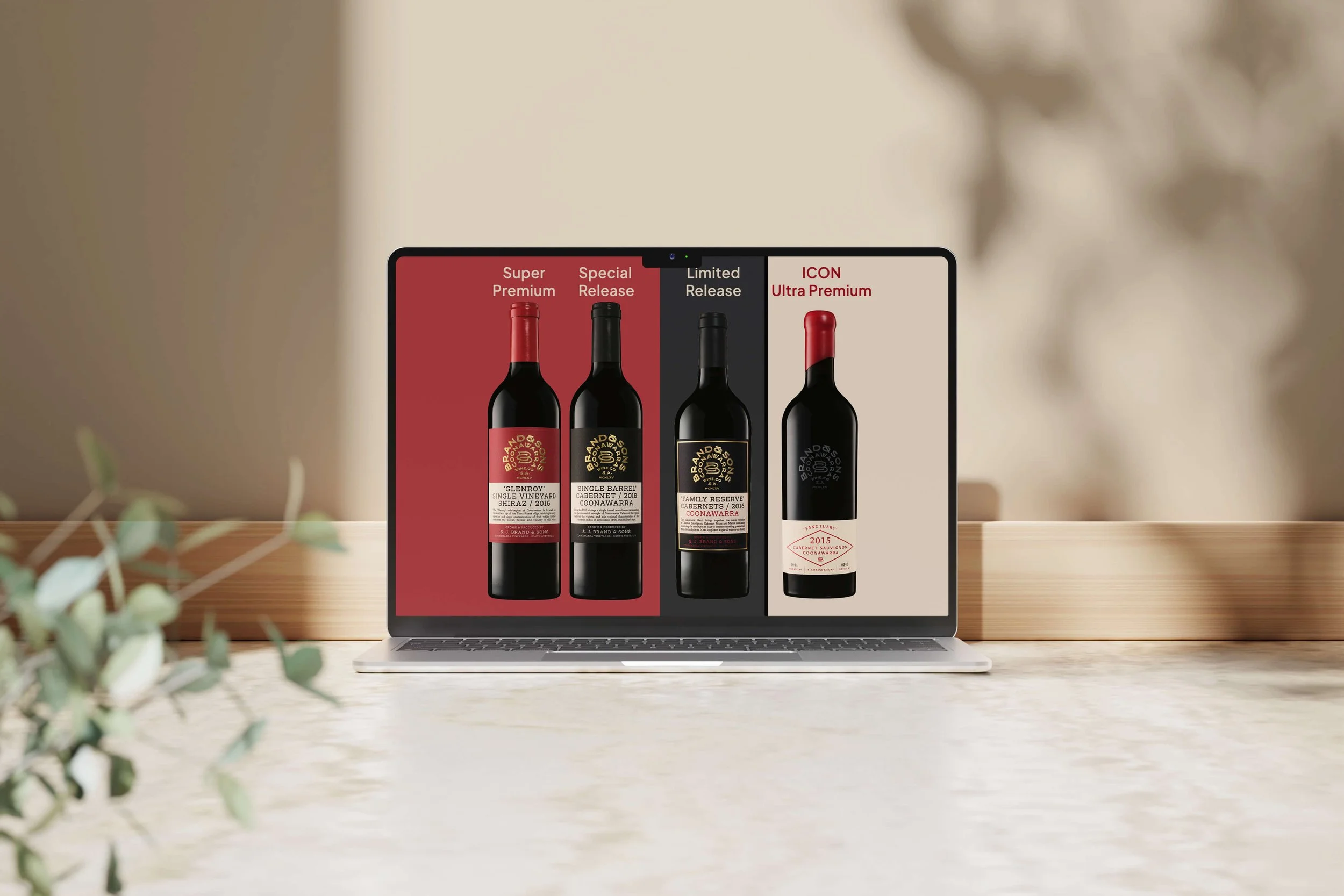 Laptop screen displaying four bottles of wine with labels and categories labeled 'Super Premium,' 'Special Release,' 'Limited Release,' and 'ICON Ultra Premium'.
