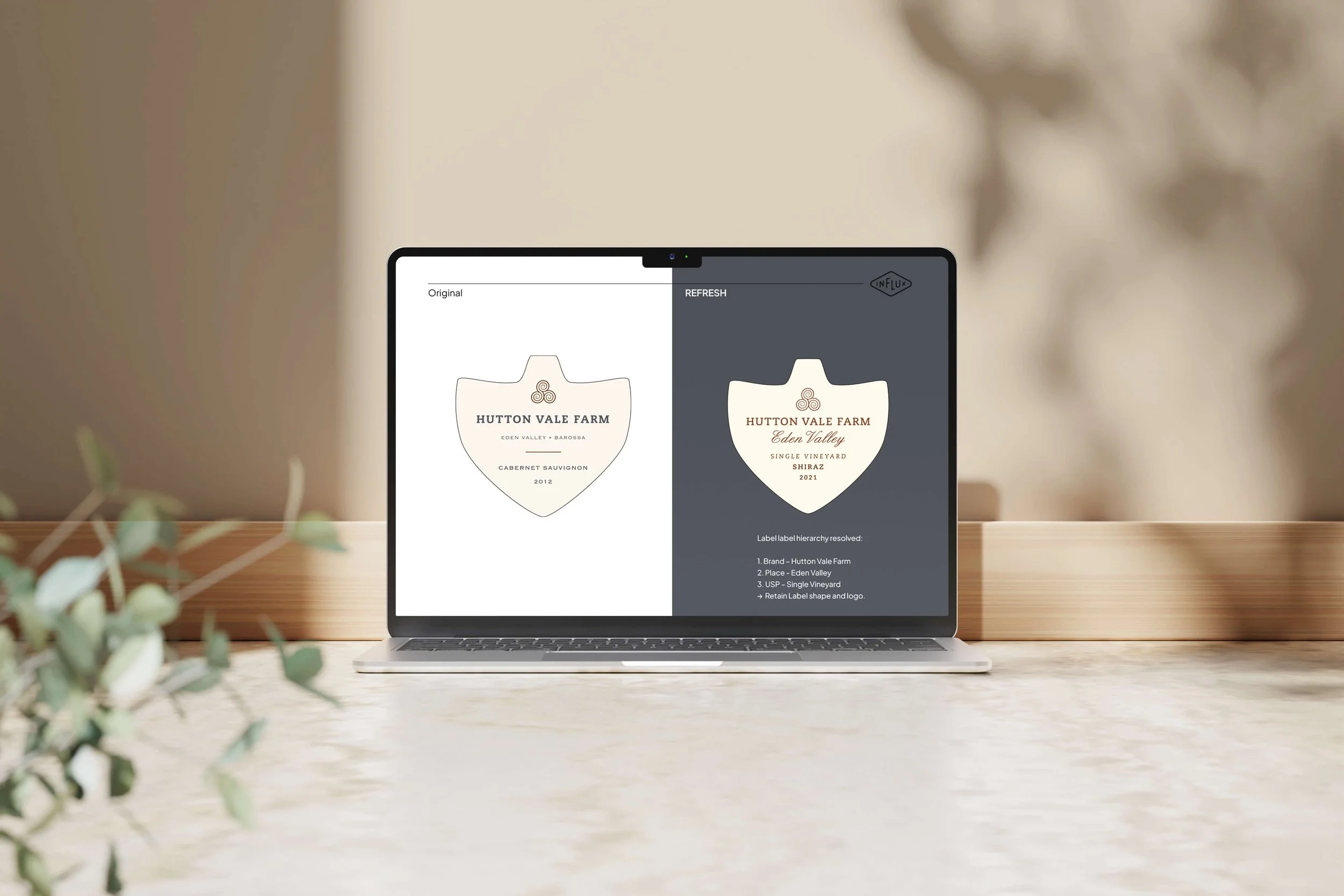 Laptop displaying a logo design for Hutton Vale Farm wine label, showing a comparison of original and refreshed versions.