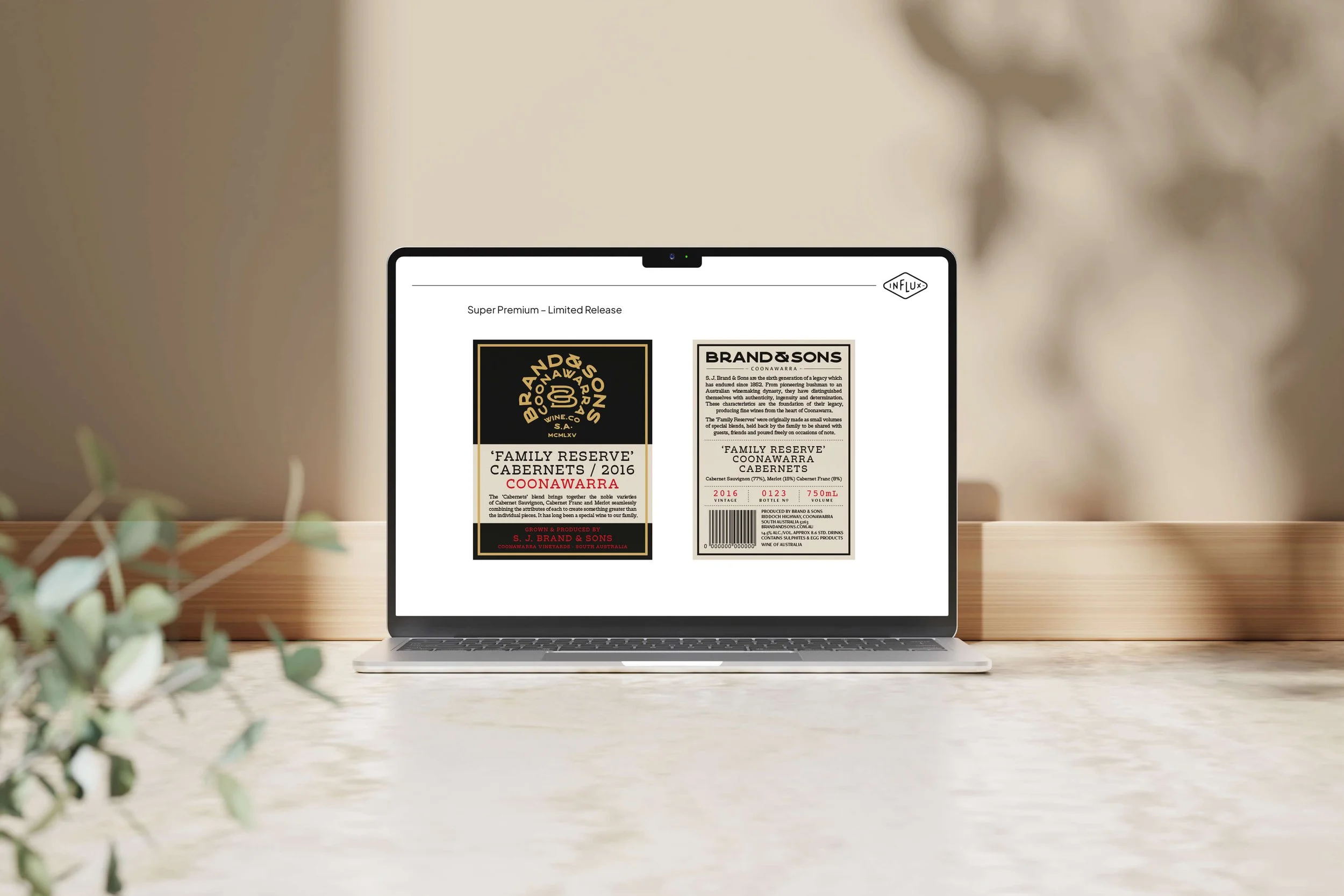 Laptop on a table displaying wine label designs for Brand & Sons' Family Reserve Cabernet from Coonawarra, Australia.