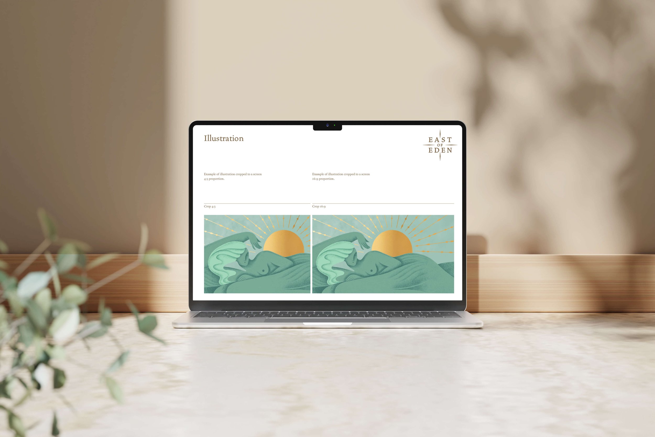 Open laptop on a wooden table displaying a webpage with illustrations of a reclining figure, the sun, and rays, with a blurred plant in the foreground from East of Eden Wines.