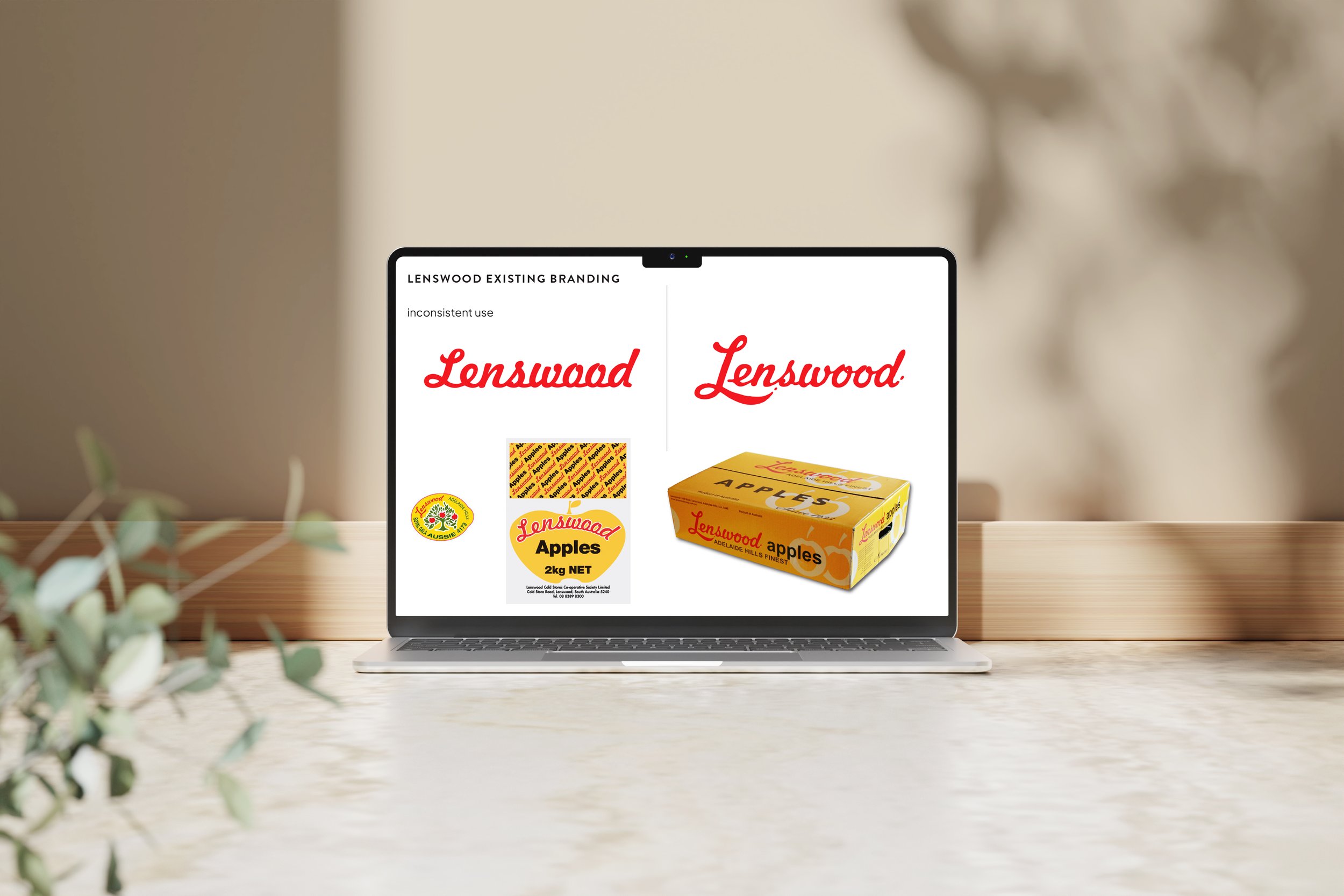 Computer screen displaying branding of Lenswood, showcasing the word 'Lenswood' in red cursive font, with product packaging of apples and related logos.