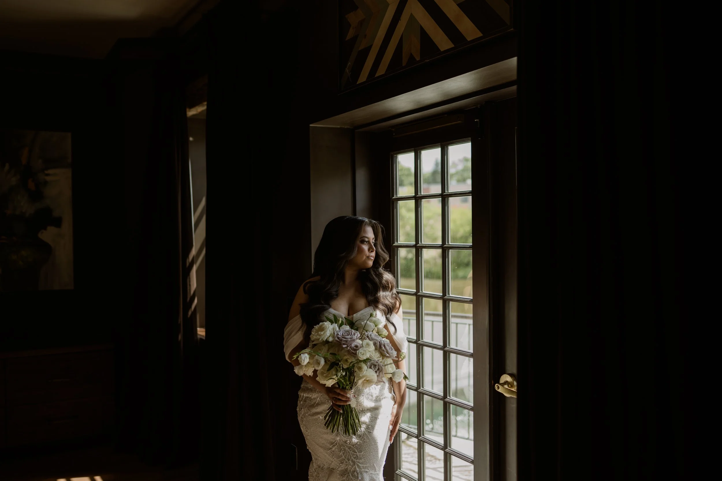 A woman dressed in White wedding dress, vows, white wedding flowers, hamilton wedding venue, ancaster mill