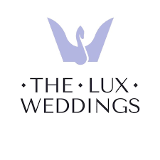 Logo for The Lux Weddings featuring a stylized purple hand with two fingers forming a V shape above the company name