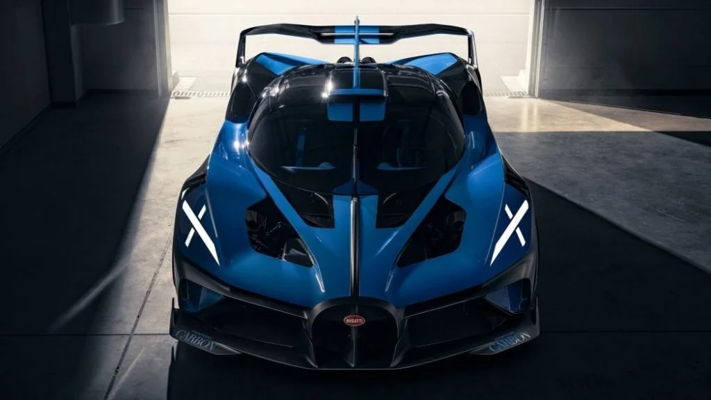Bugatti Bolide hypercar in blue with aggressive front aero, photographed inside a garage, representing extreme track performance.
