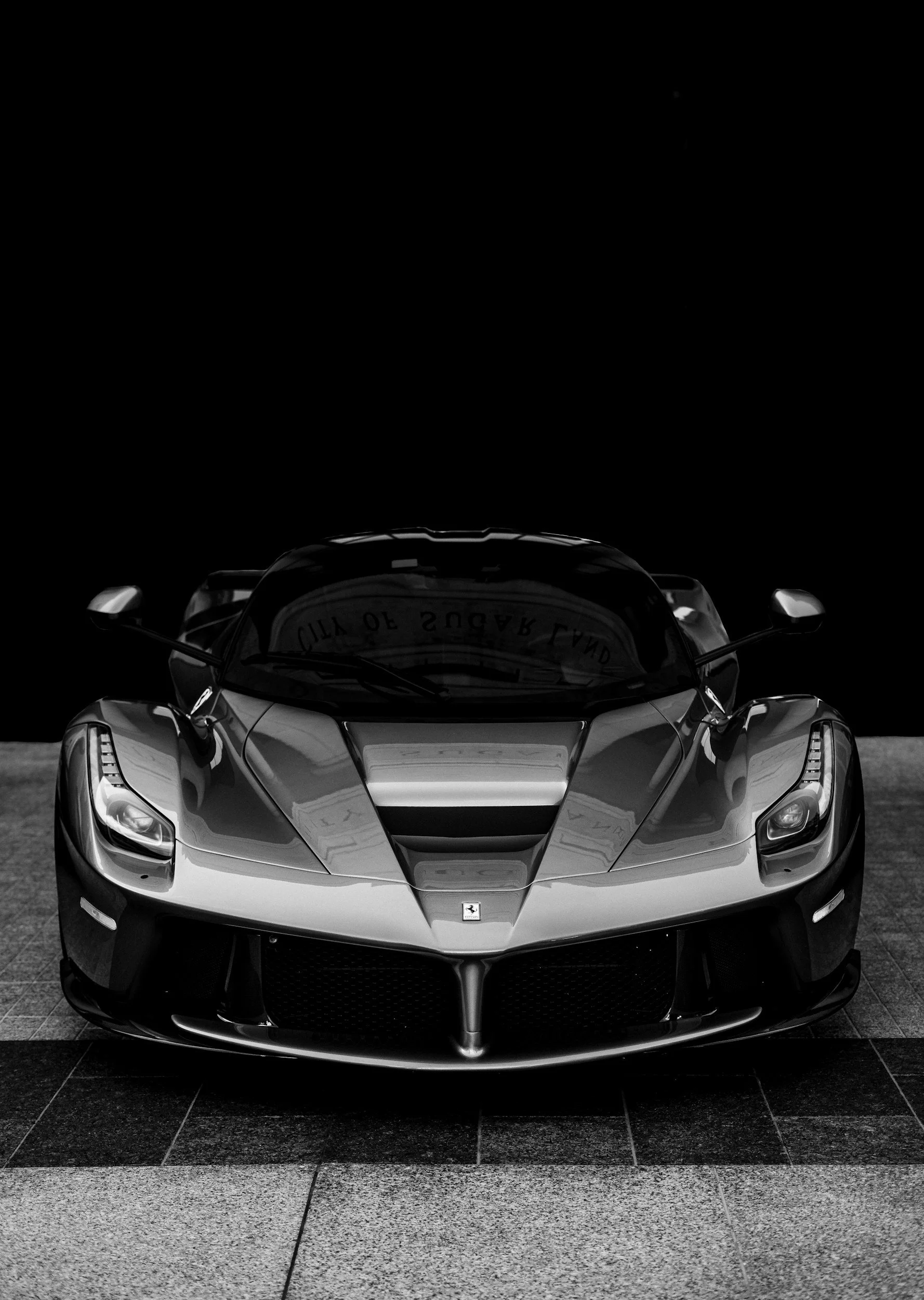 Black Ferrari LaFerrari photographed from the front, representing high-end supercar ownership and elite performance engineering.