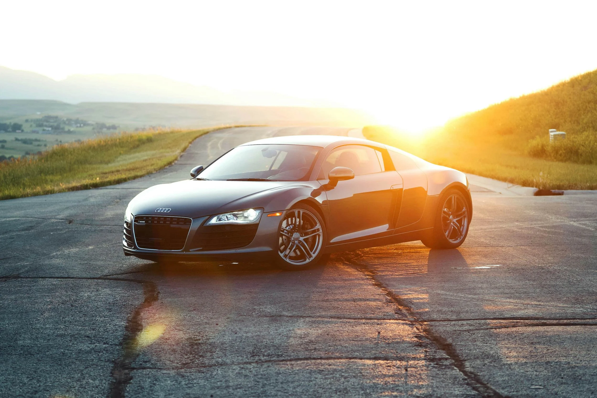 Audi R8 parked on a scenic road at sunset, representing luxury and performance car finance in Australia.
