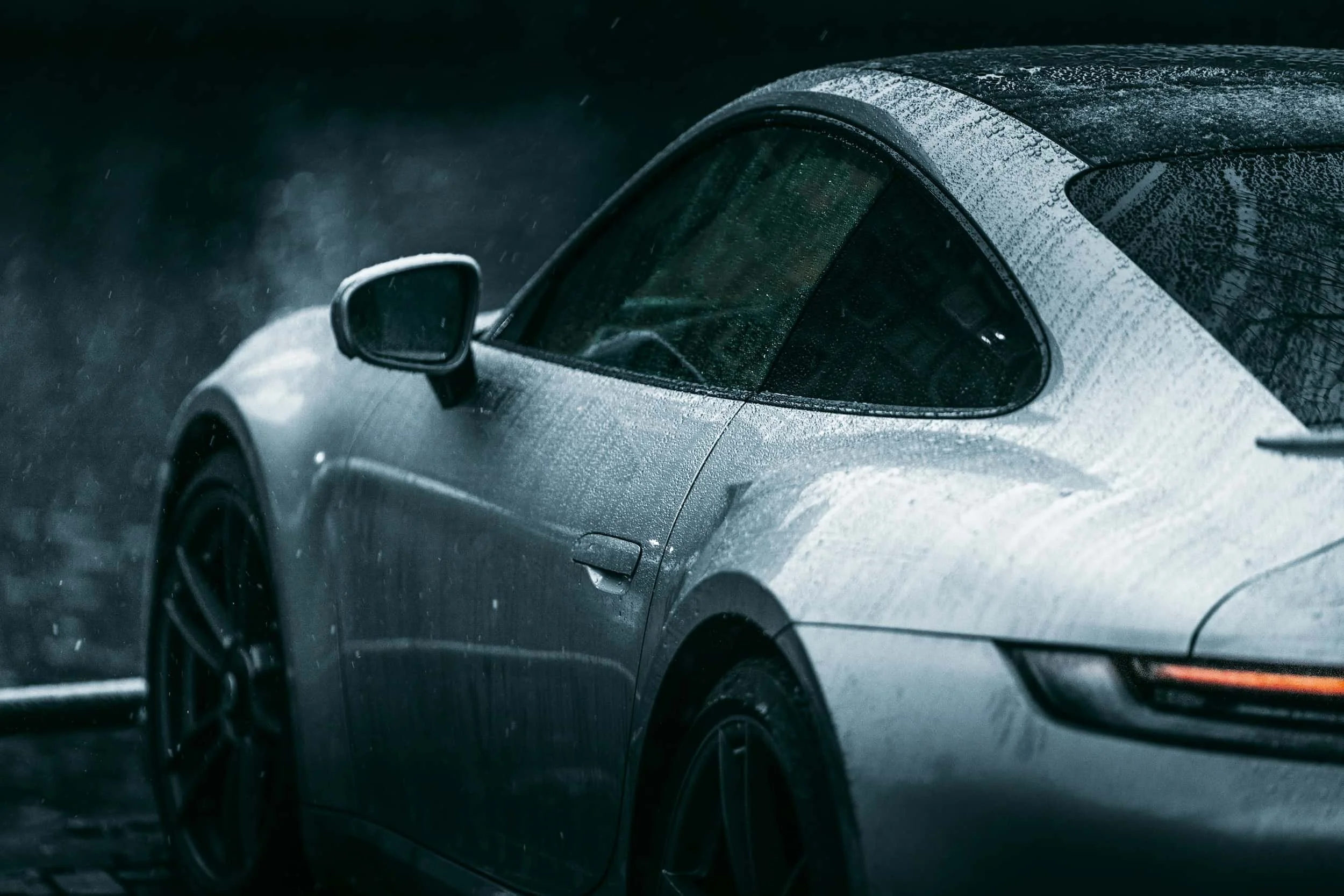 Porsche sports car in the rain, representing precision engineering and high-performance supercar finance options.