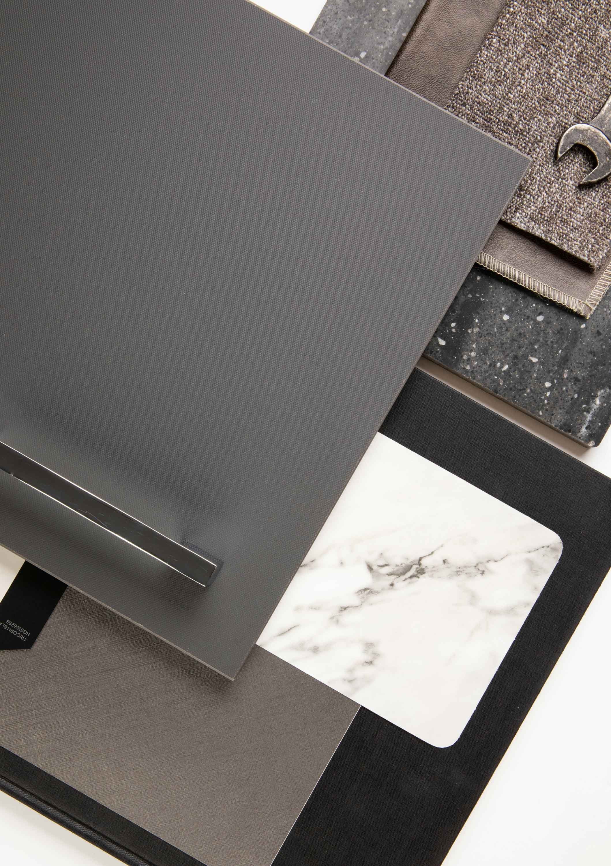 Samples of countertop materials, including gray textured laminate, black granite, speckled gray, white marble, and solid black surfaces.
