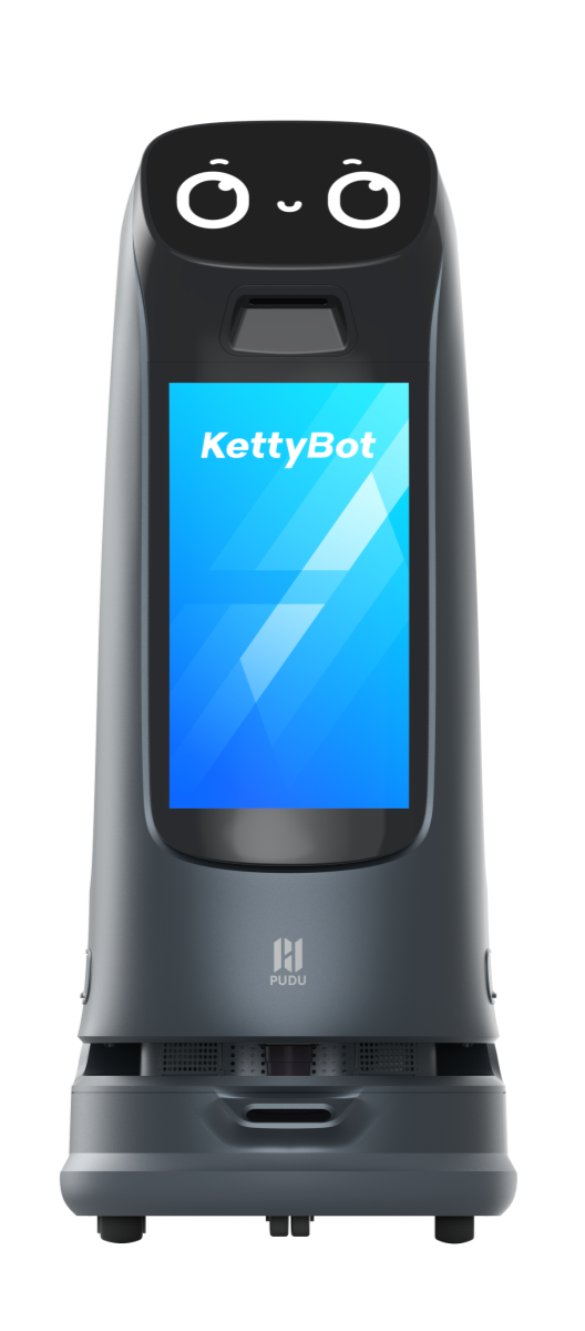A sleek, gray robotic device with a digital screen displaying 'KettyBot' and a cute, animated face on the top, resembling a friendly robot assistant.