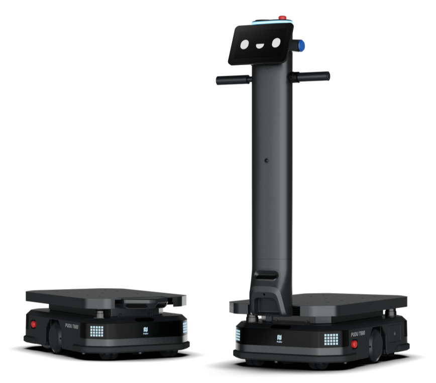 Two black autonomous delivery robots with flat platforms for packages, one with a smiling robot face on its screen, and the other with a tall vertical arm, set against a plain background.